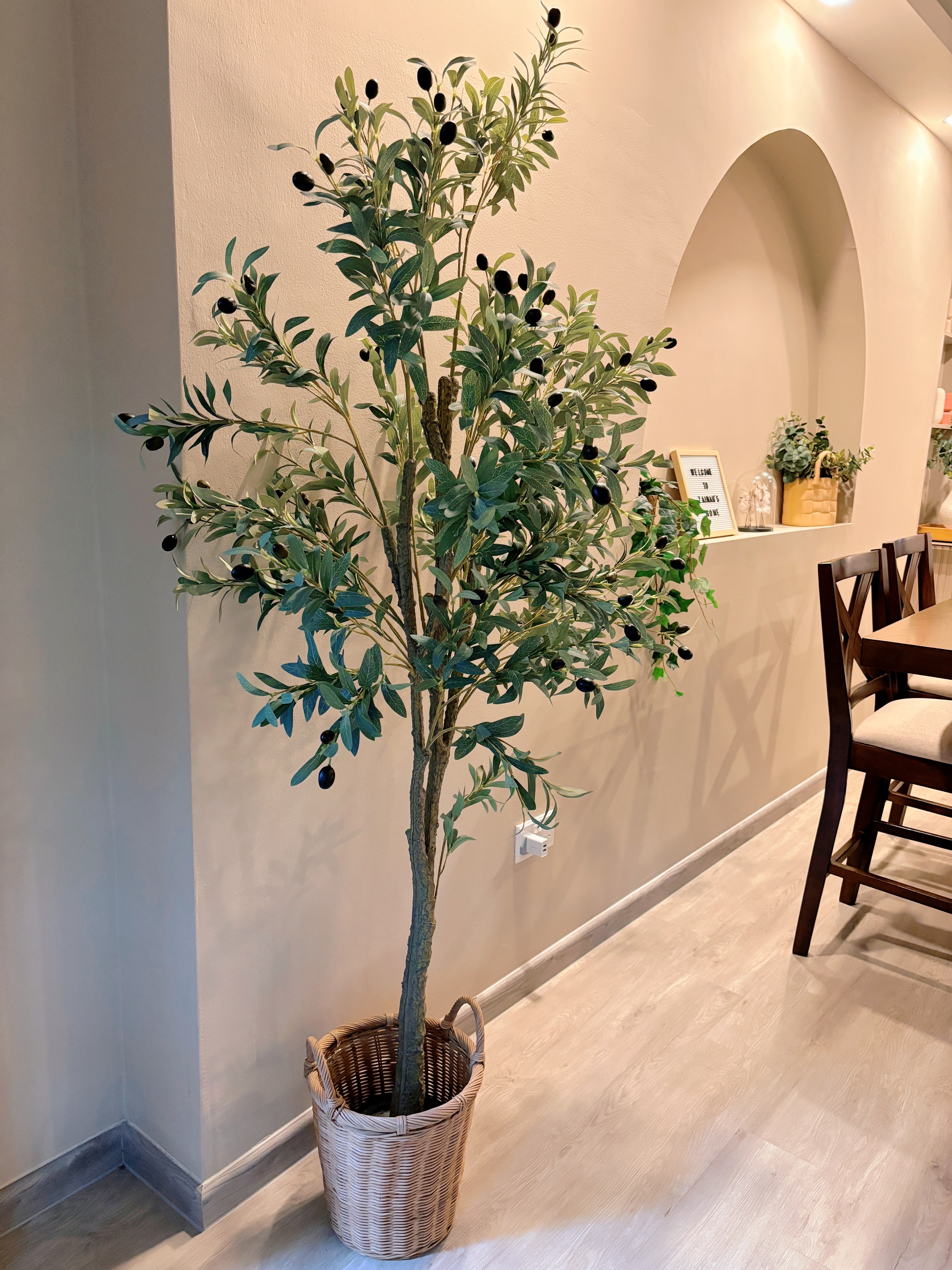 Sprucing Up Home Decor: Adding Greens for a Fresh Touch - Lush green plant with dark purple olives growing in a woven basket