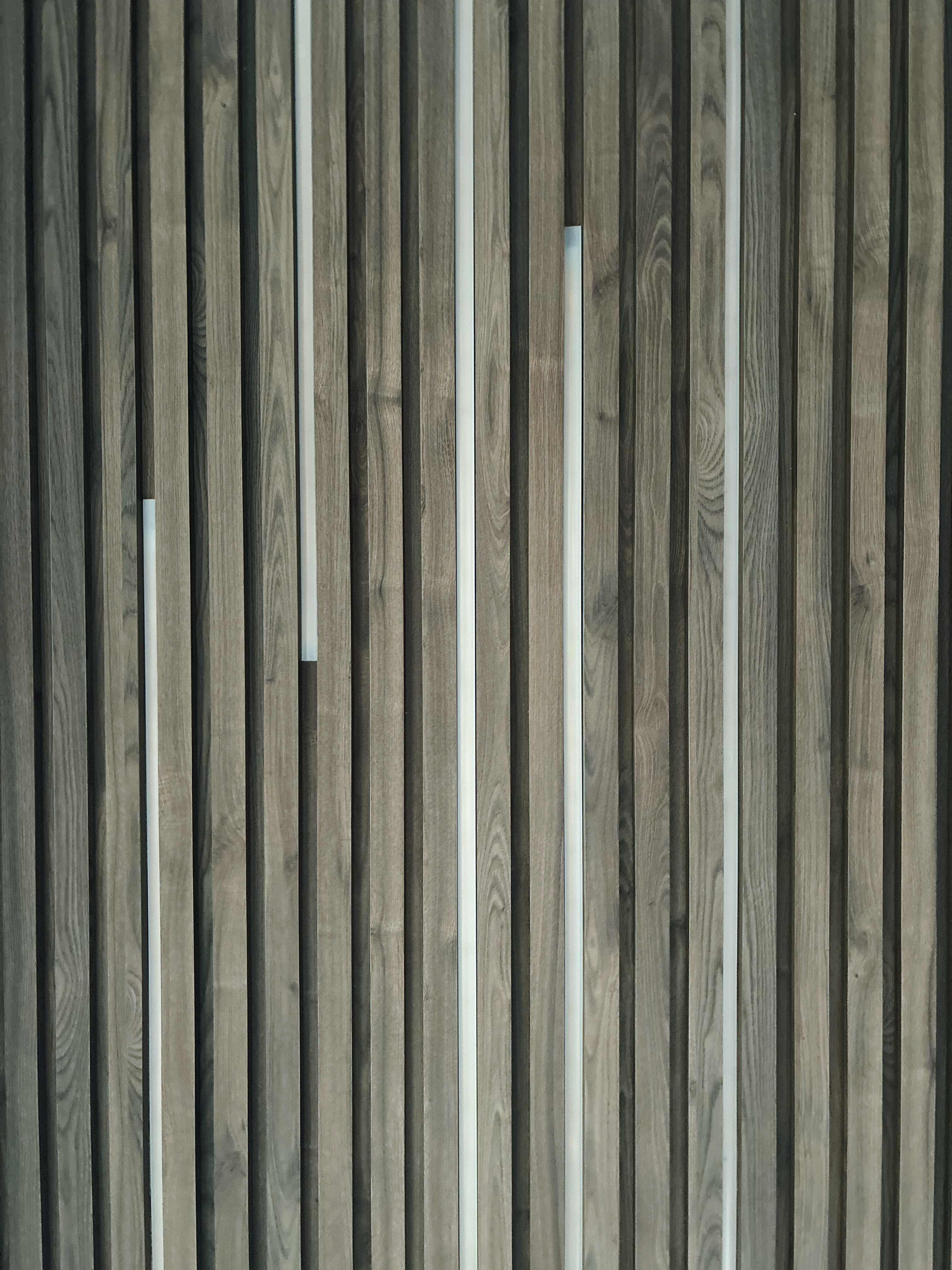Minimal Effort, Maximum Comfort: Welcome to Our Living Room - Wooden panel, vertical slats, natural wood grain, texture, wood