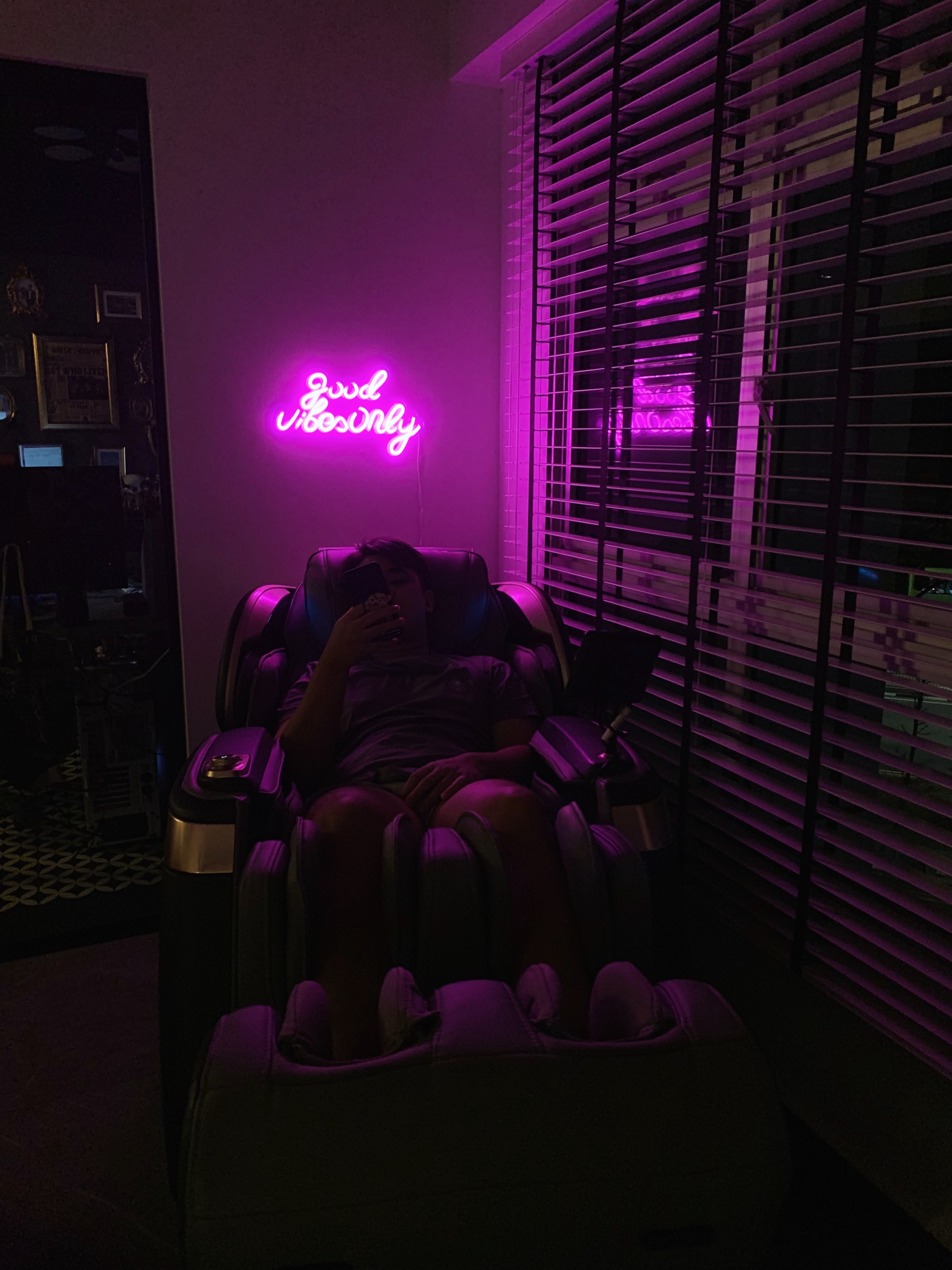 Minimal Effort, Maximum Comfort: Welcome to Our Living Room - Neon sign "Good Vibes Only" illuminates the room, , Person