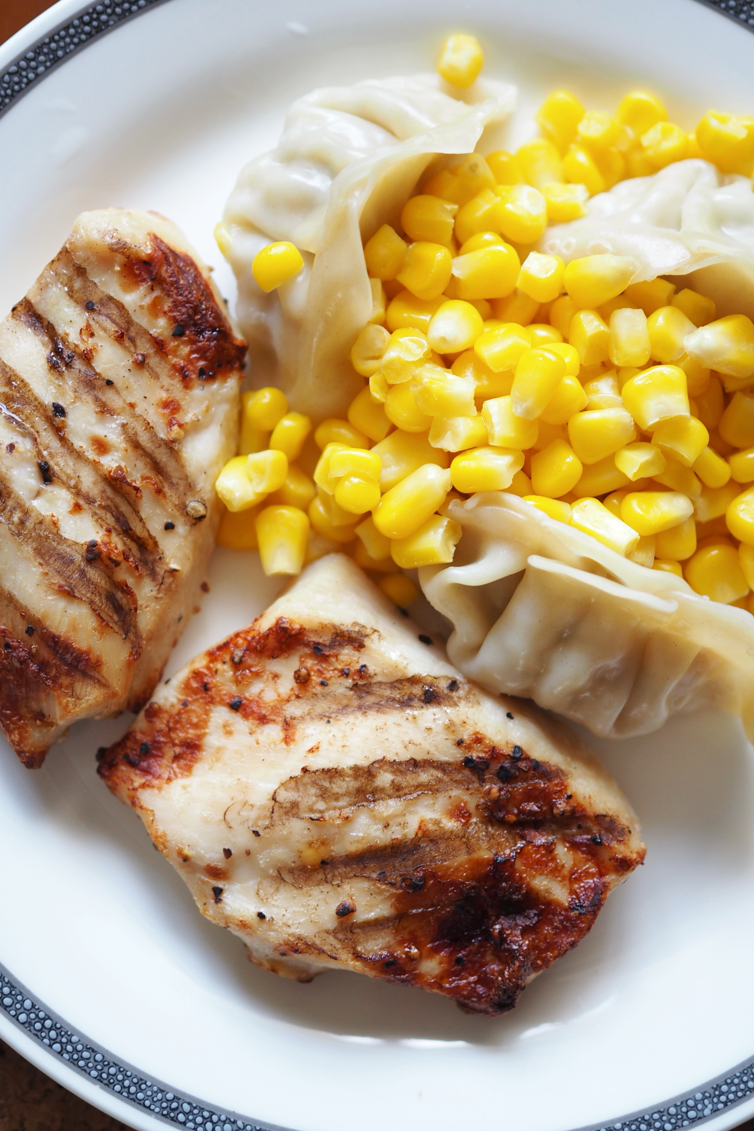 Effortless cooking: Our favourite appliances for quick and easy meals - Grilled chicken, dumplings, corn, white plate