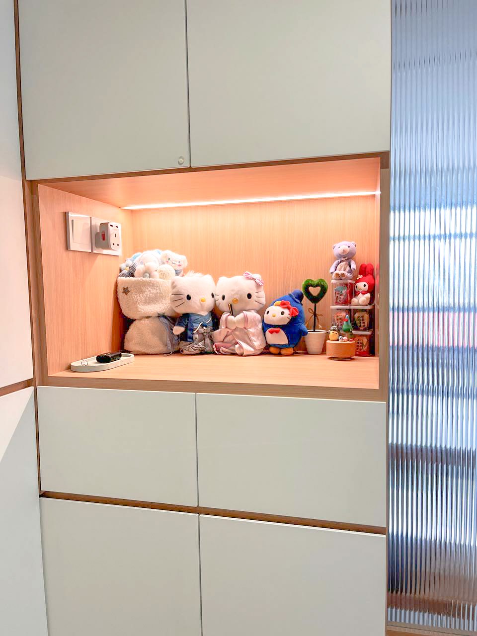Japandi-inspired entry way with fully functional storage space area  - Wooden cabinet, soft toys, Hello Kitty, plush animals