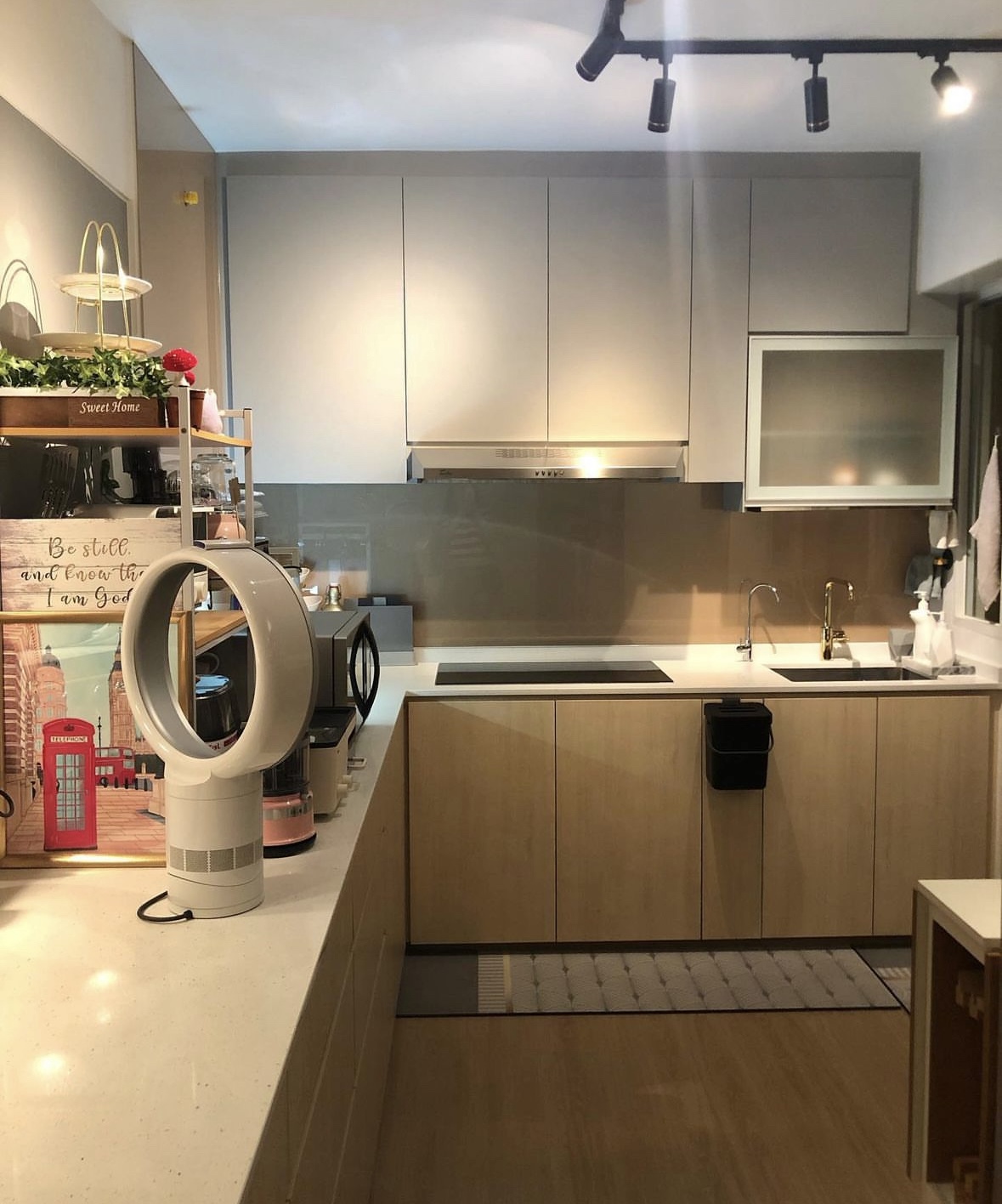 Favourite Spots for the Weekend Homies - Modern kitchen with sleek design, light wood cabinets, stainless steel range hood