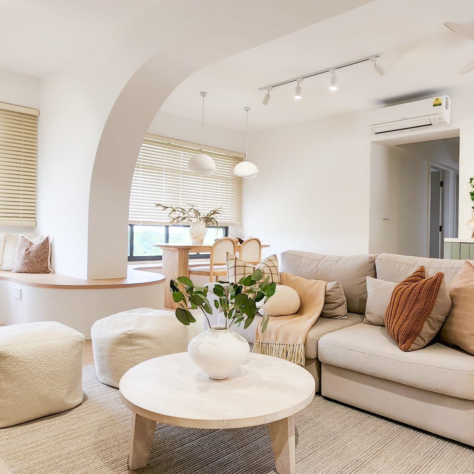 Our Living Room: Bright, Soft, and Beautifully Airy - Modern living room with beige sofa, white coffee table, cozy seating