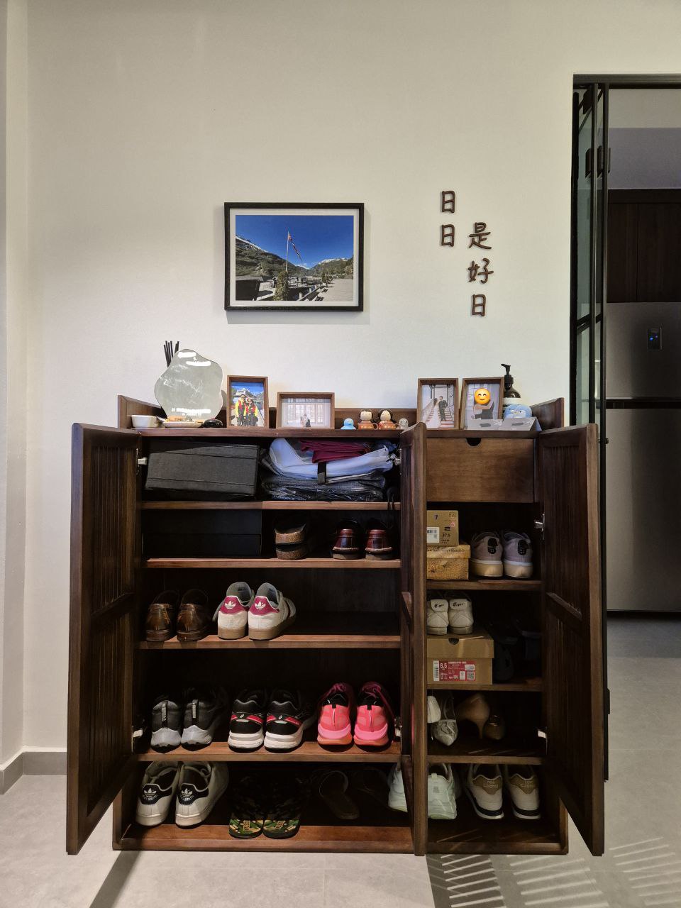 Sunset hues along our Entryway... a space for us to keep growing into - Wooden shoe cabinet, neatly organized shoes, various
