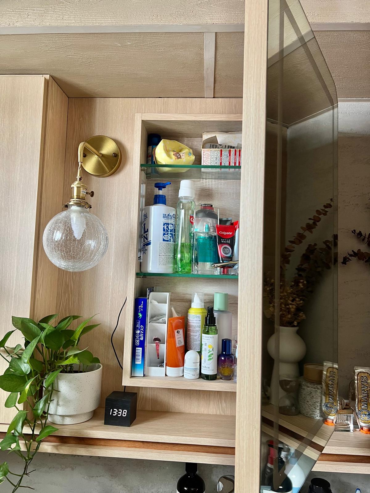 Secret Spaces: Unveiling Peek-a-Boo Hidden Storage Around Our House!  - Wooden medicine cabinet, glass shelves, neatly