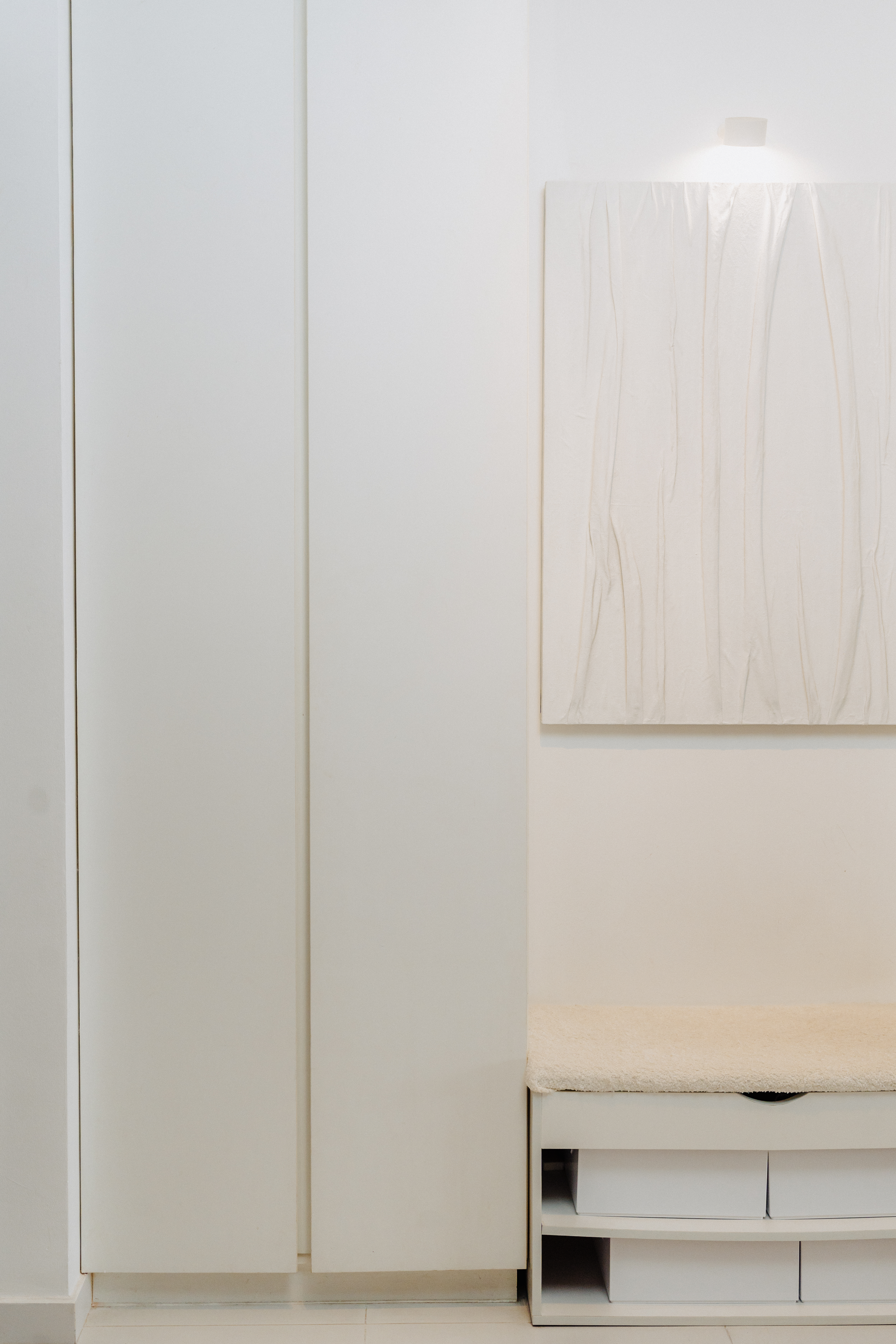 Our Entryway: Creating A Functional And Aesthetic Space With DIY  - Minimalist white cabinet, abstract art, soft lighting