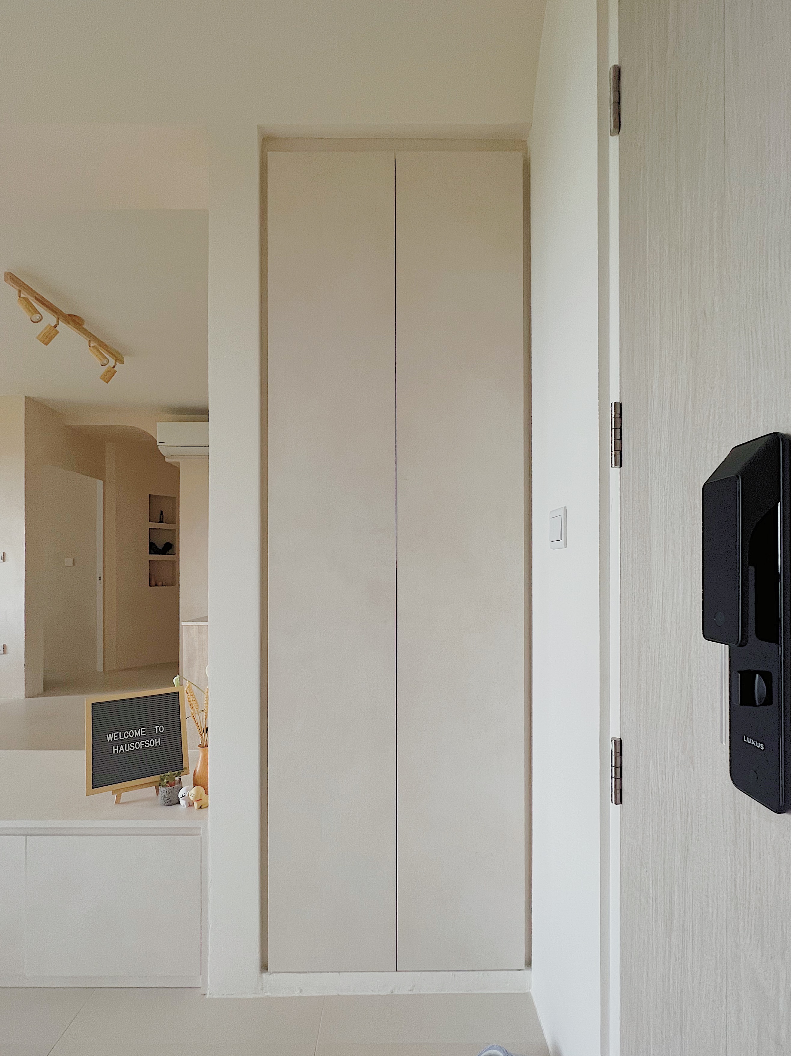 Welcome Home: Embracing Clutter-free Living - Minimalist interior, modern design, neutral color palette, large wardrobe, open