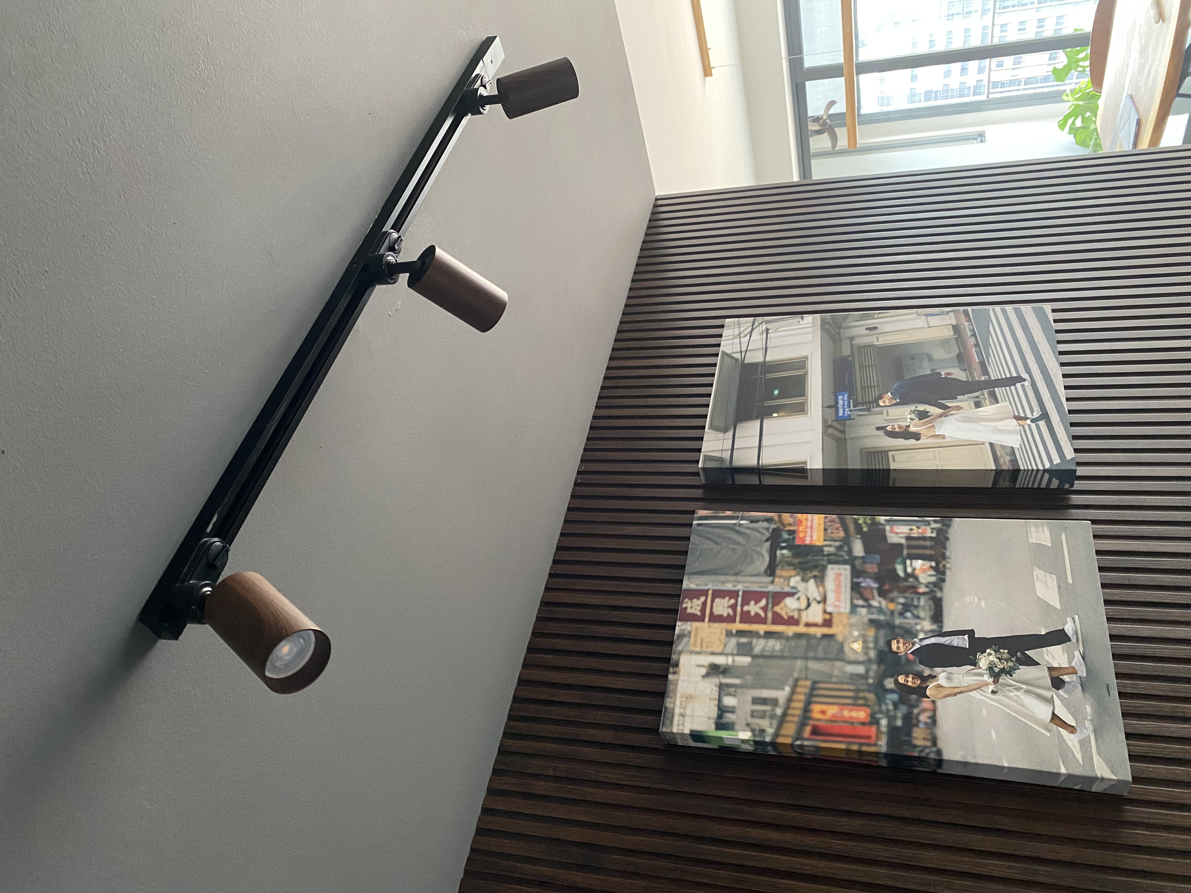 Gallery style entryway with dark wood fluted panel - modern interior, stylish decor, minimalist design, wall-mounted lamp