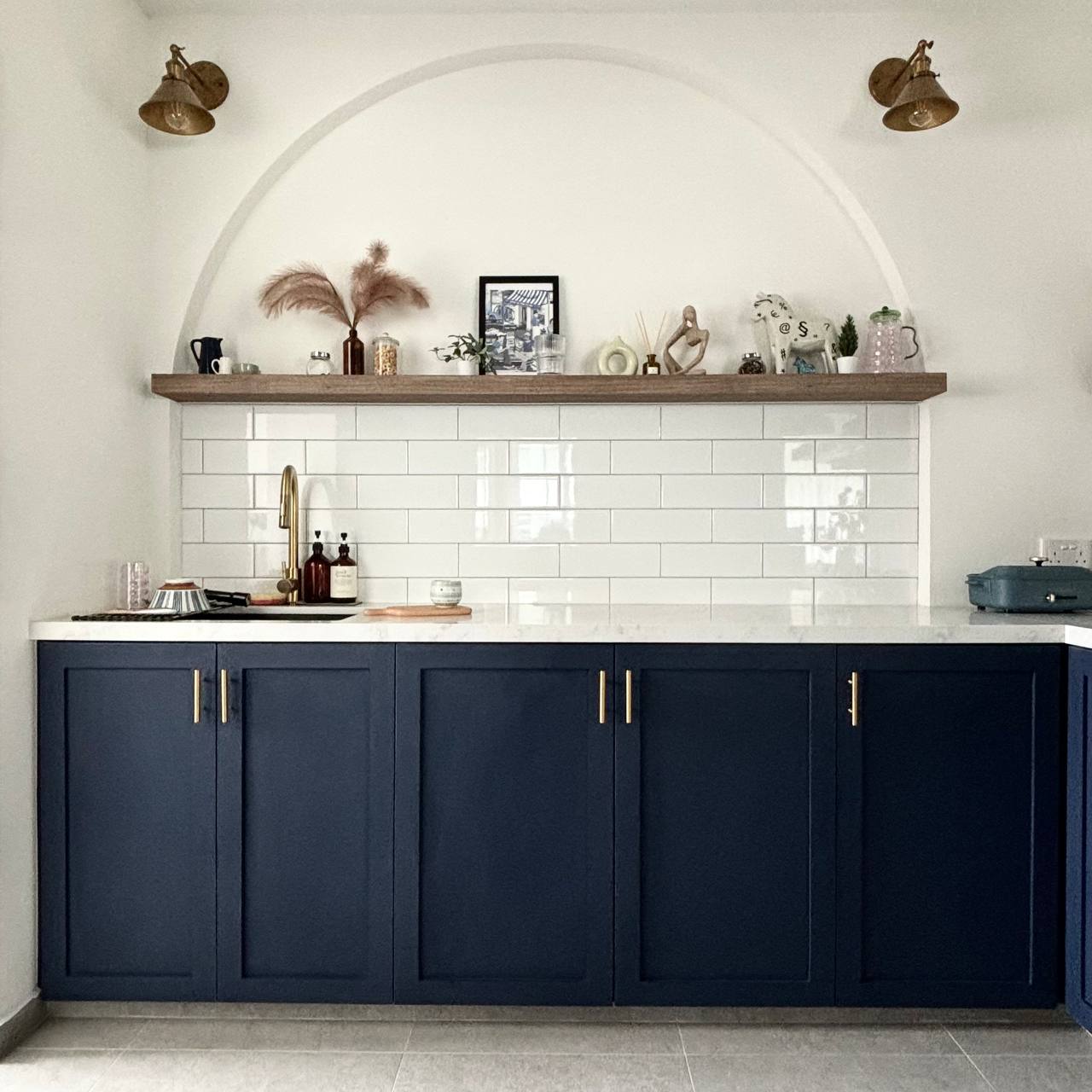 Hidden in plain sight - can you spot the hidden elements in our home? - Dark blue kitchen cabinets with gold handles, white