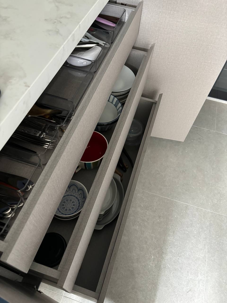 Hidden in plain sight - can you spot the hidden elements in our home? - Dishwasher drawer, neatly organized dishes, kitchen