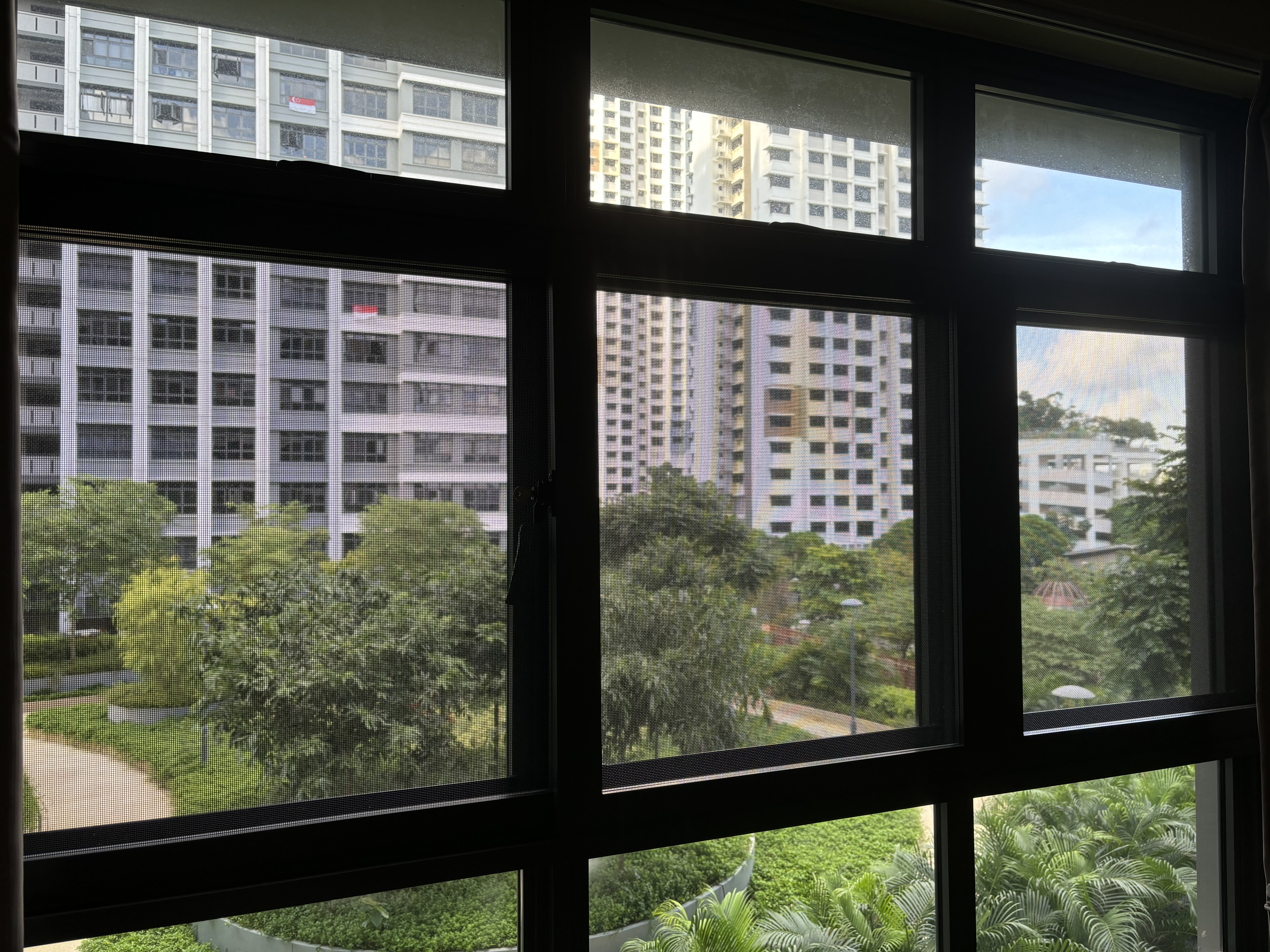 3-in-1 Security Mesh: Insect proof, child proof and cat proof  - Modern urban landscape, large windows, green foliage, tall