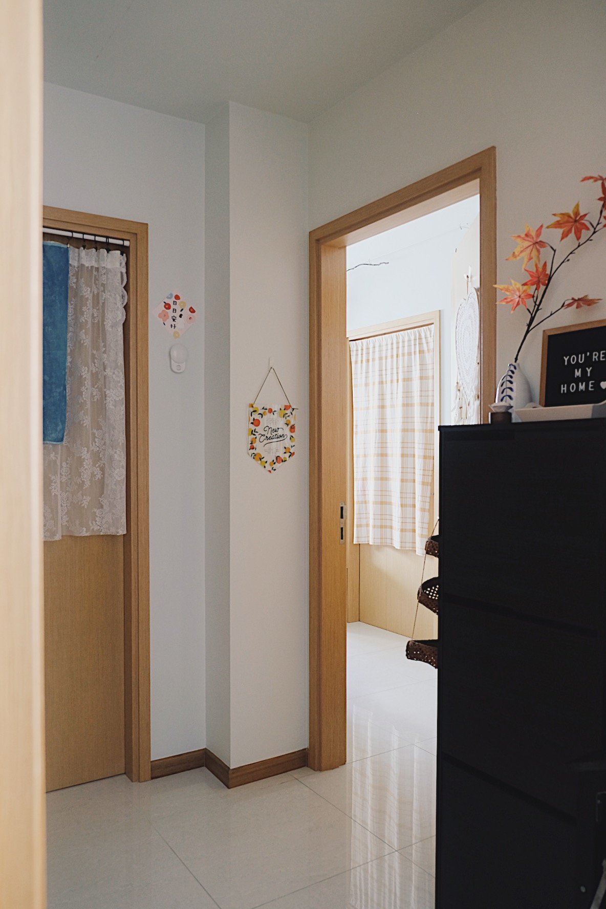 Cube-sized Foyer in a Dual-key Apt with a shoe rack and decor touches - Wooden door, light-colored walls, tiled floor