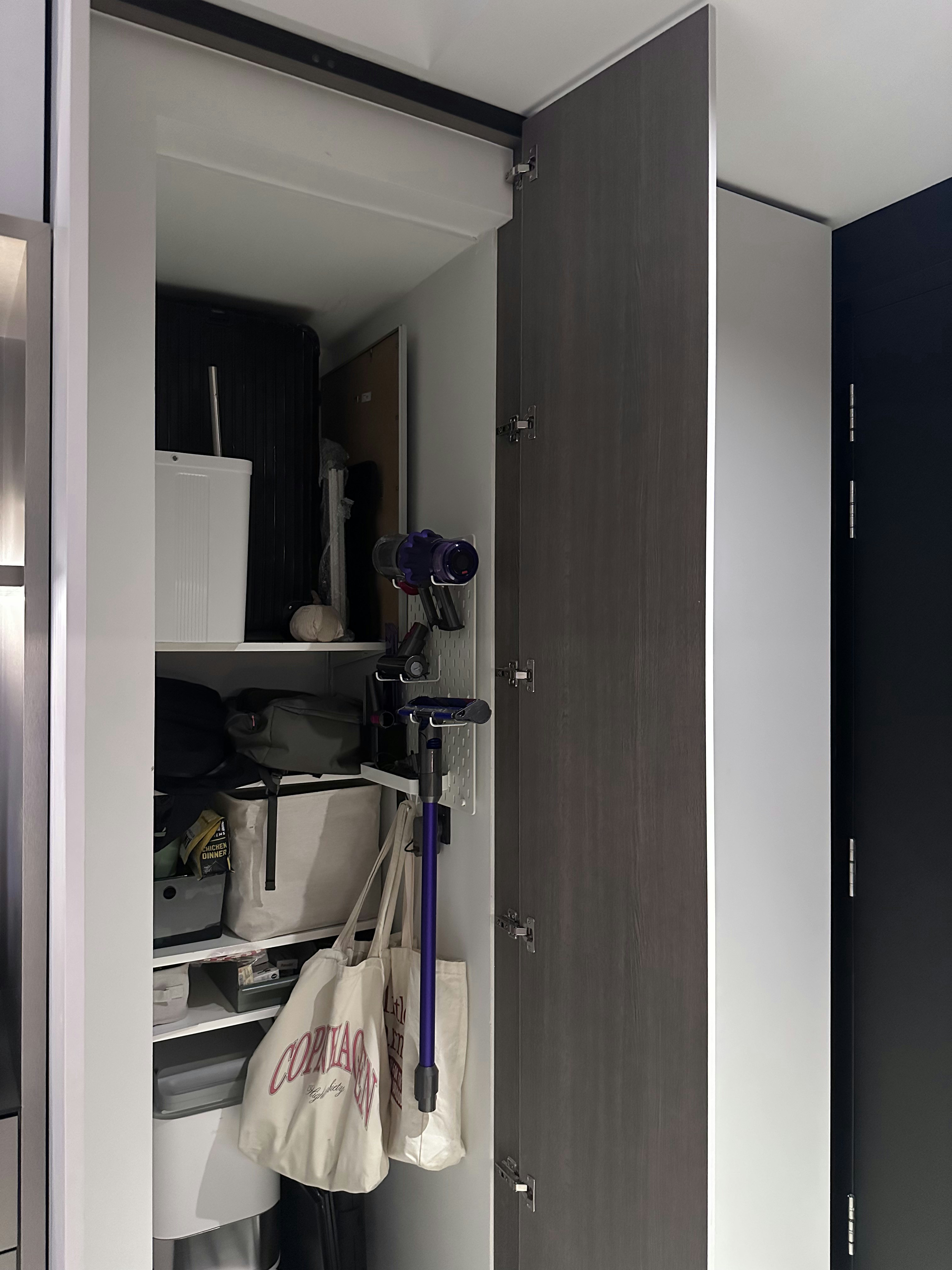 A Seamless Welcome: Introducing Our Stylish Entryway - Storage space, closet, open door, shelves, bags, backpack, suitcase