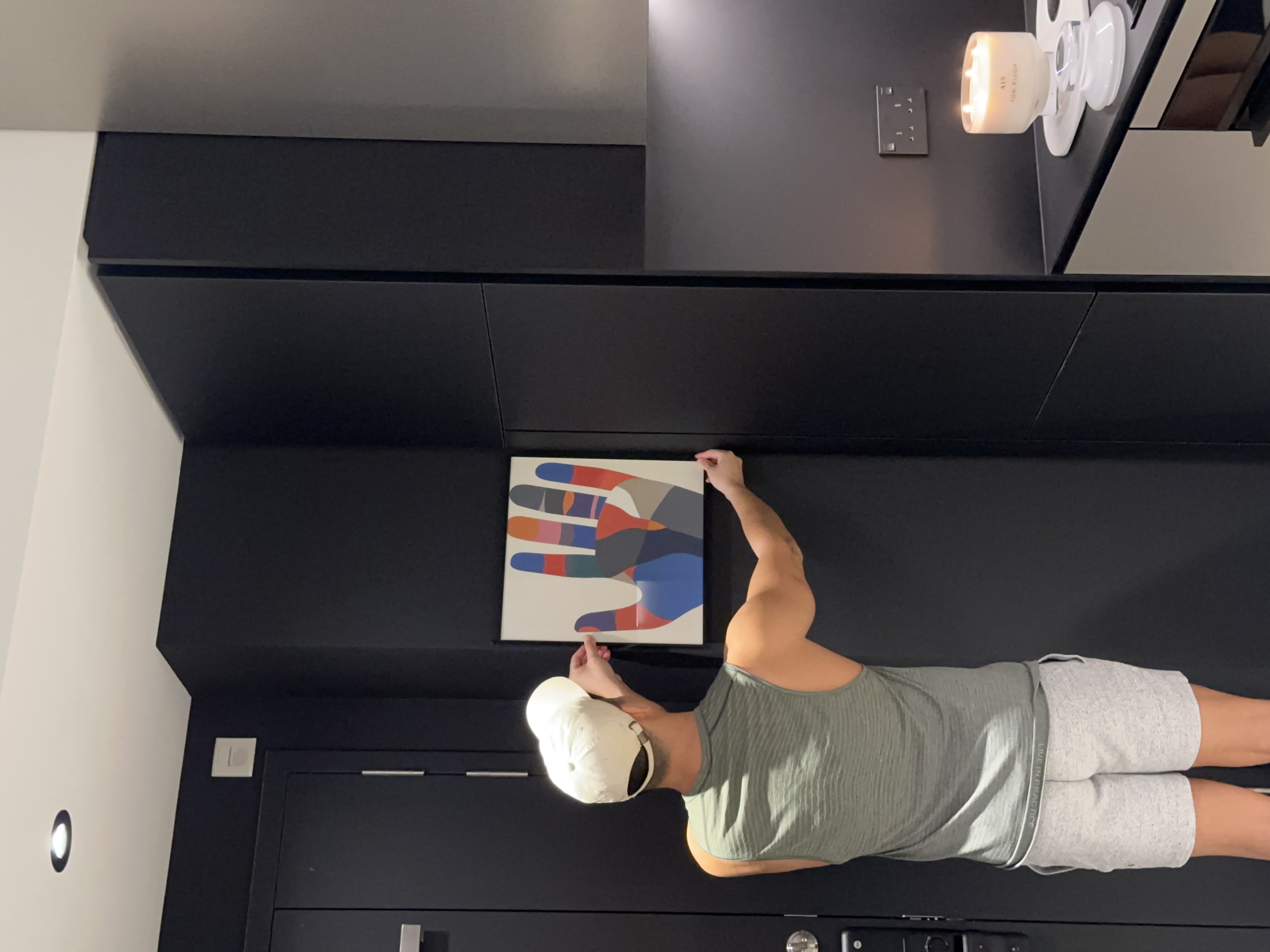 A Seamless Welcome: Introducing Our Stylish Entryway - Modern minimalist interior, sleek black cabinets, abstract artwork