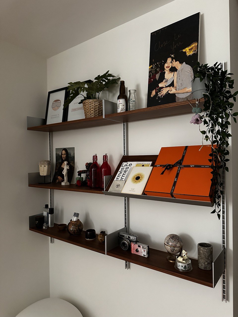 Not covering up your bomb shelter with a feature wall? No problem! - Wooden shelves, minimalist decor, black and white art