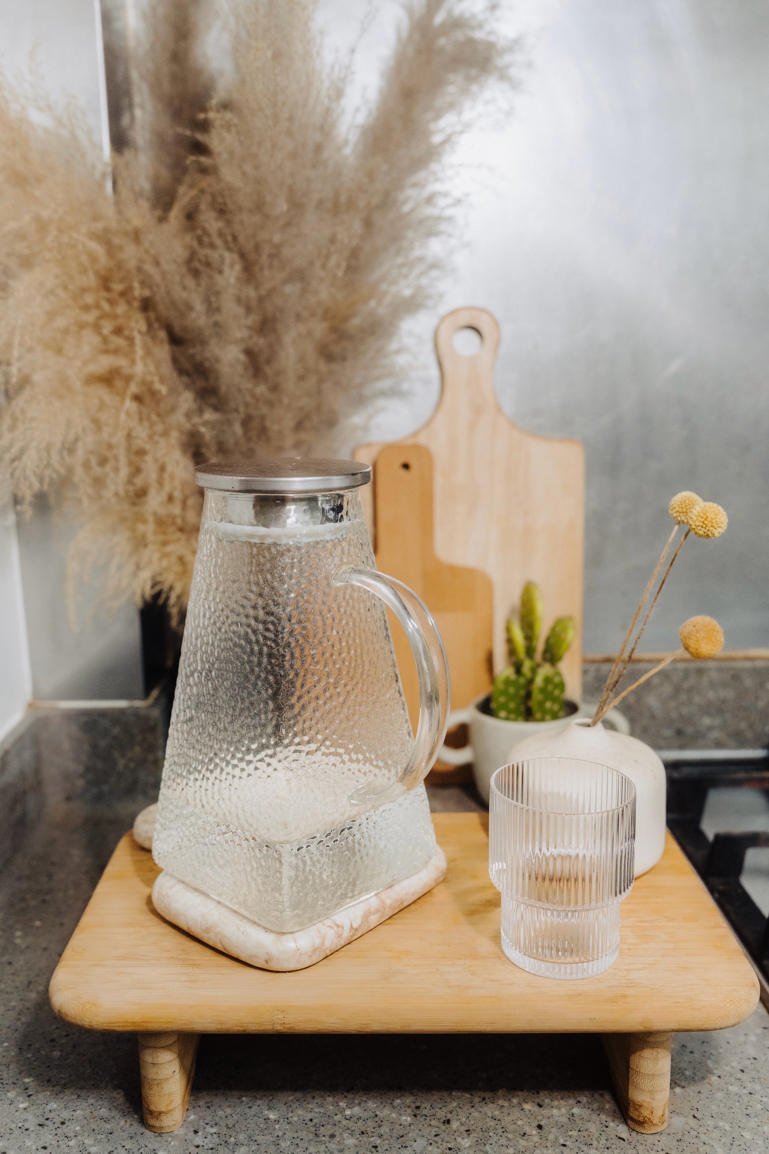 Our Standard Kitchen That Came With Our DBSS: How We Live With It - Clear glass pitcher, rustic countertop, wooden cutting