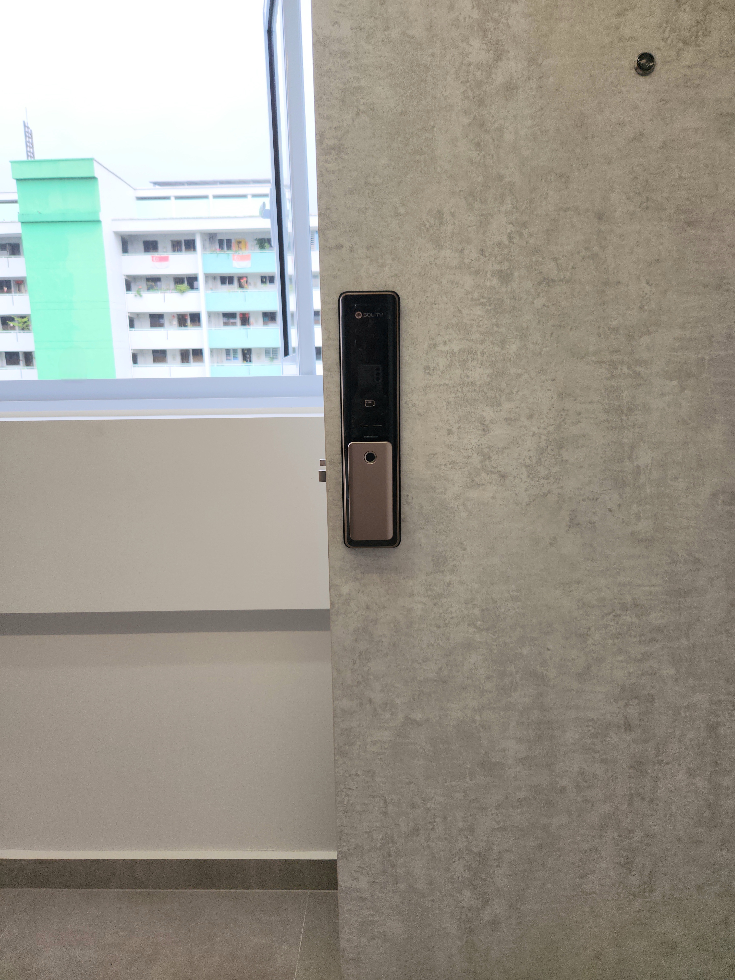 No build-ins for our Entryway - Modern minimalist wall, textured gray finish, sleek black doorbell, digital camera, indoor