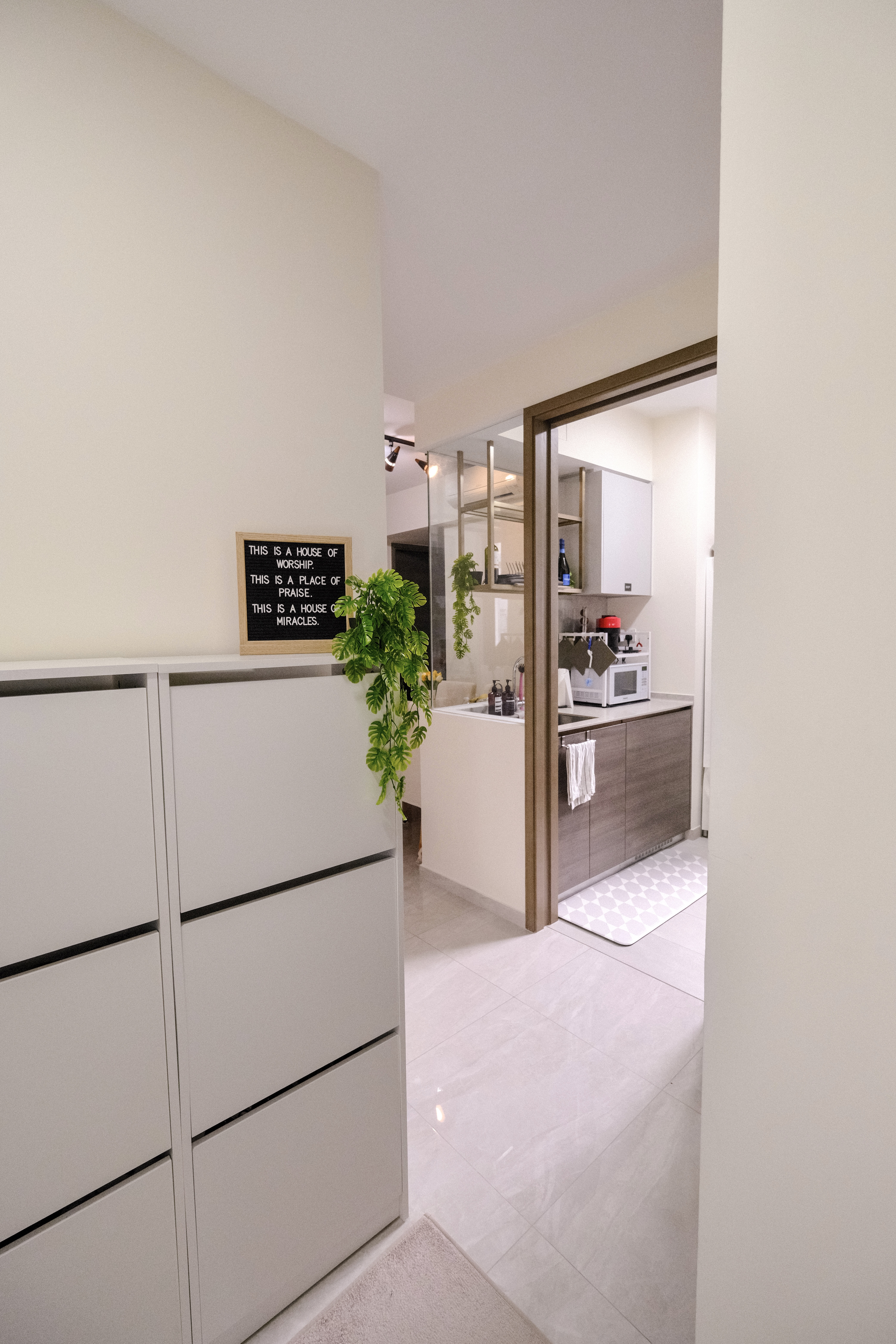 Step into our minimalist entryway!  - White kitchen cabinets, minimalist design, modern kitchen, open doorway, light-colored