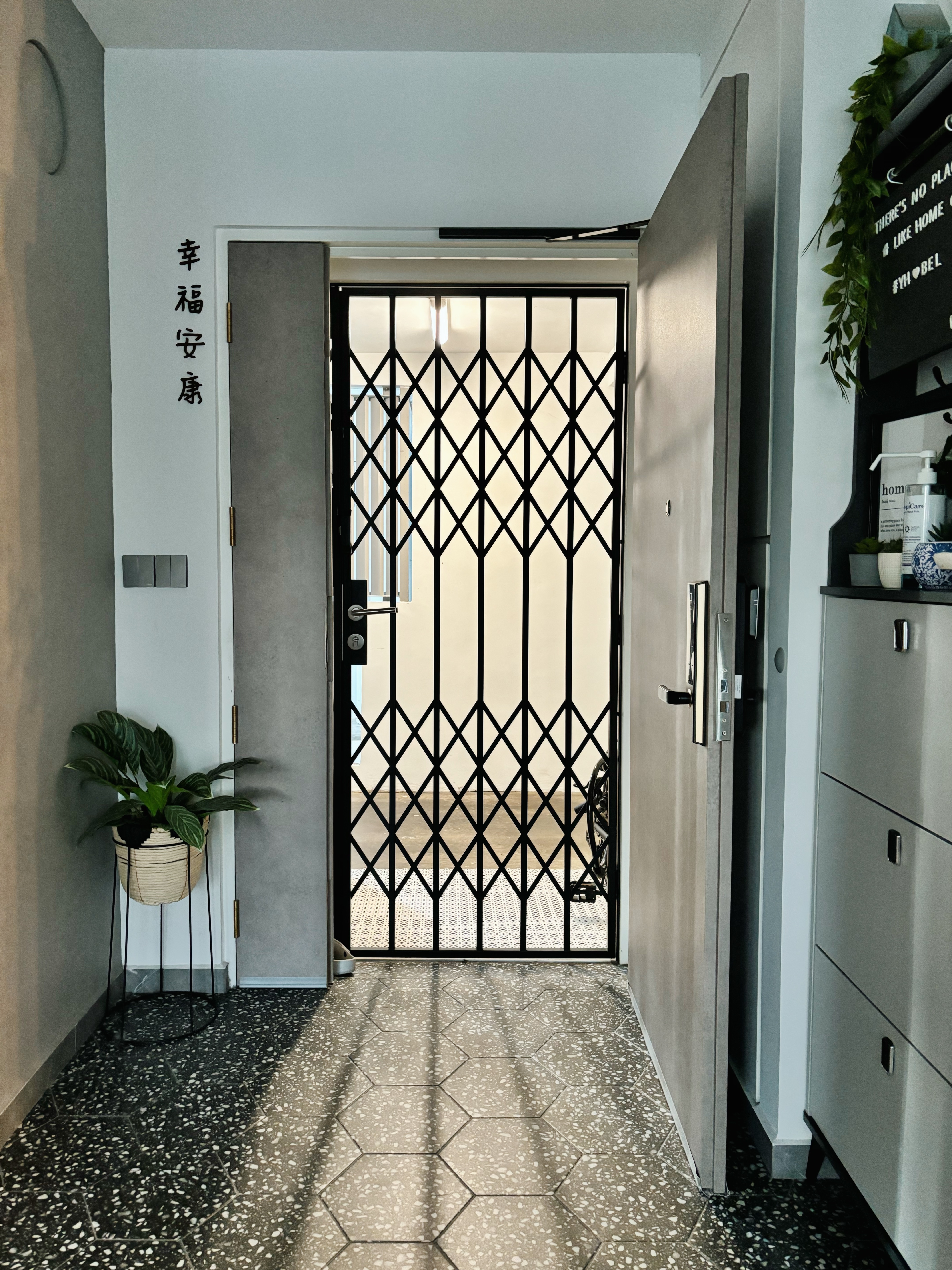 Knock Knock! Who’s There? Potterhome’s Welcoming Entryway - modern hallway, black metal gate, minimalist design, white door