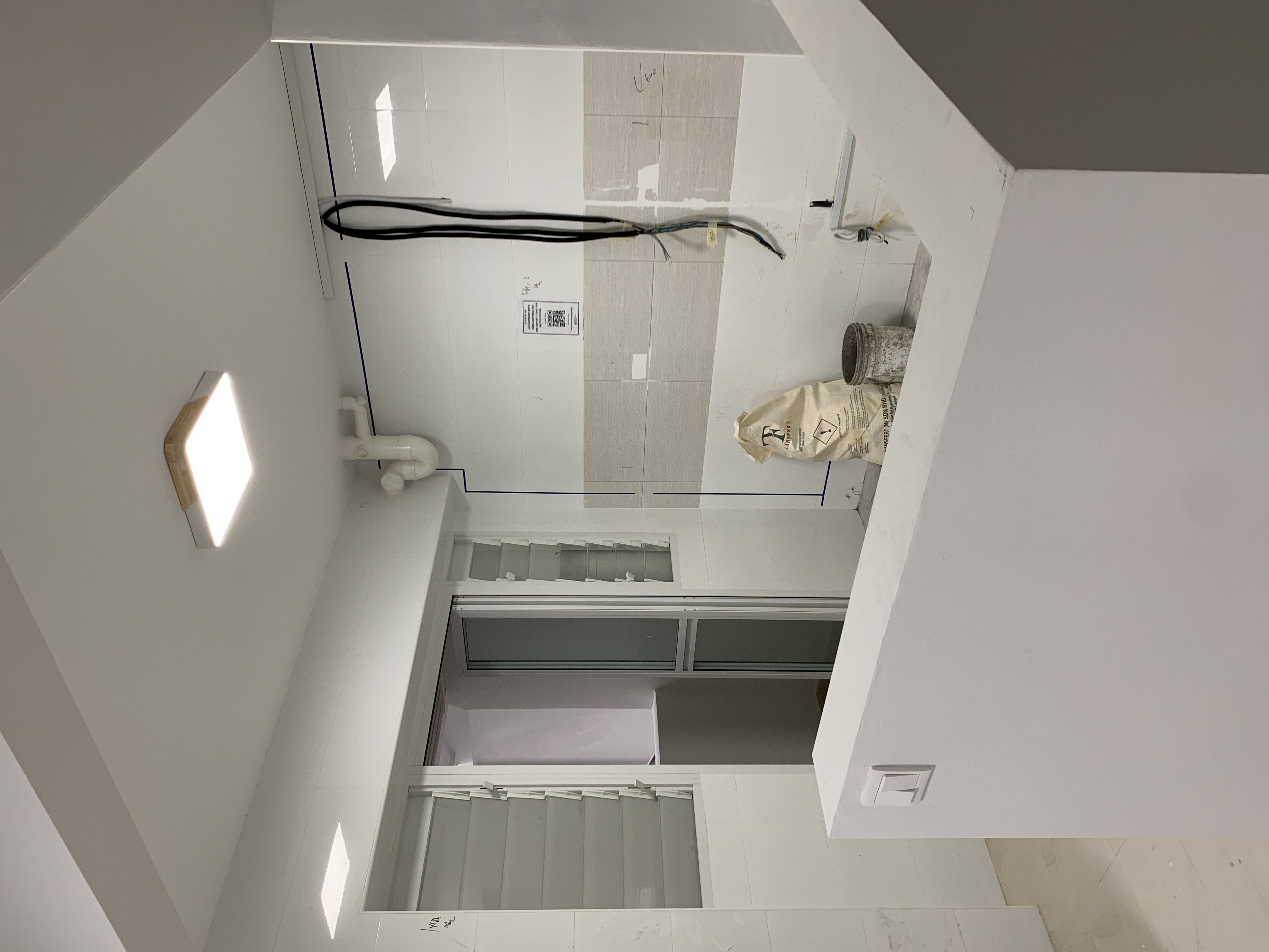 Whisking up a storm in the kitchen 🍽️ - White tiled walls, blue chalk lines, electrical wires, construction tools, beige