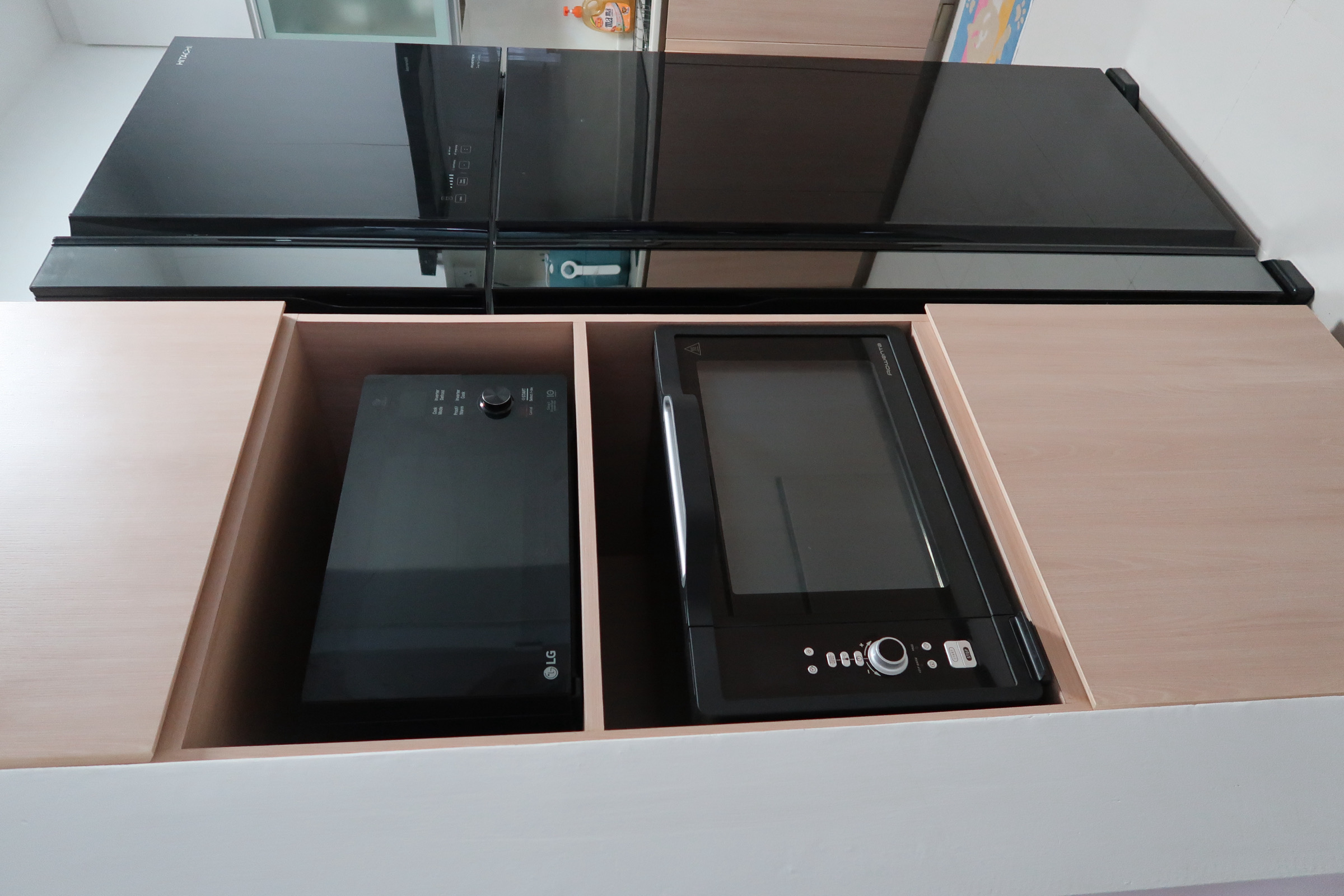 Whisking up a storm in the kitchen 🍽️ - Sleek black kitchen appliances on wooden drawers, Modern kitchen setup with LG