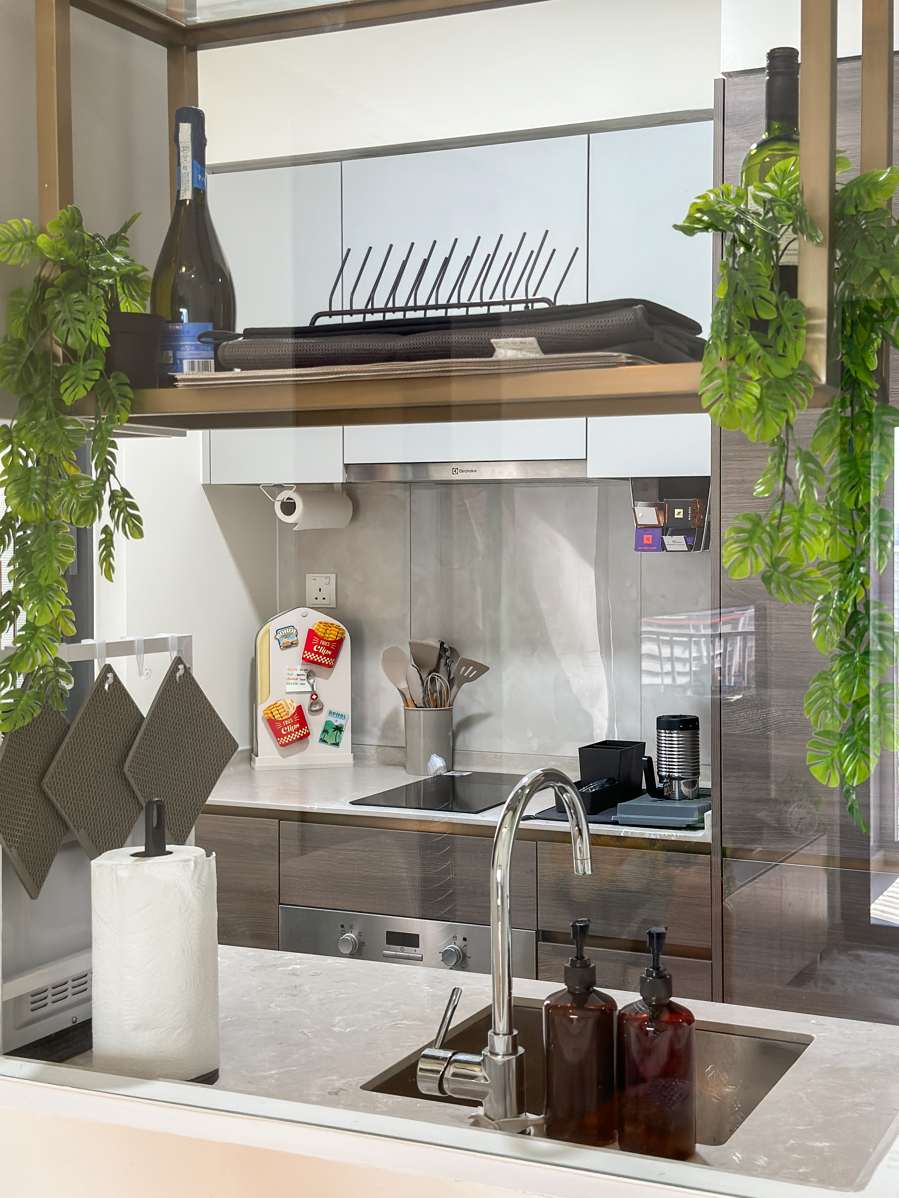 Embrace the simplicity of the kitchen! ✨ - modern kitchen, stainless steel appliances, white cabinets, hanging utensils