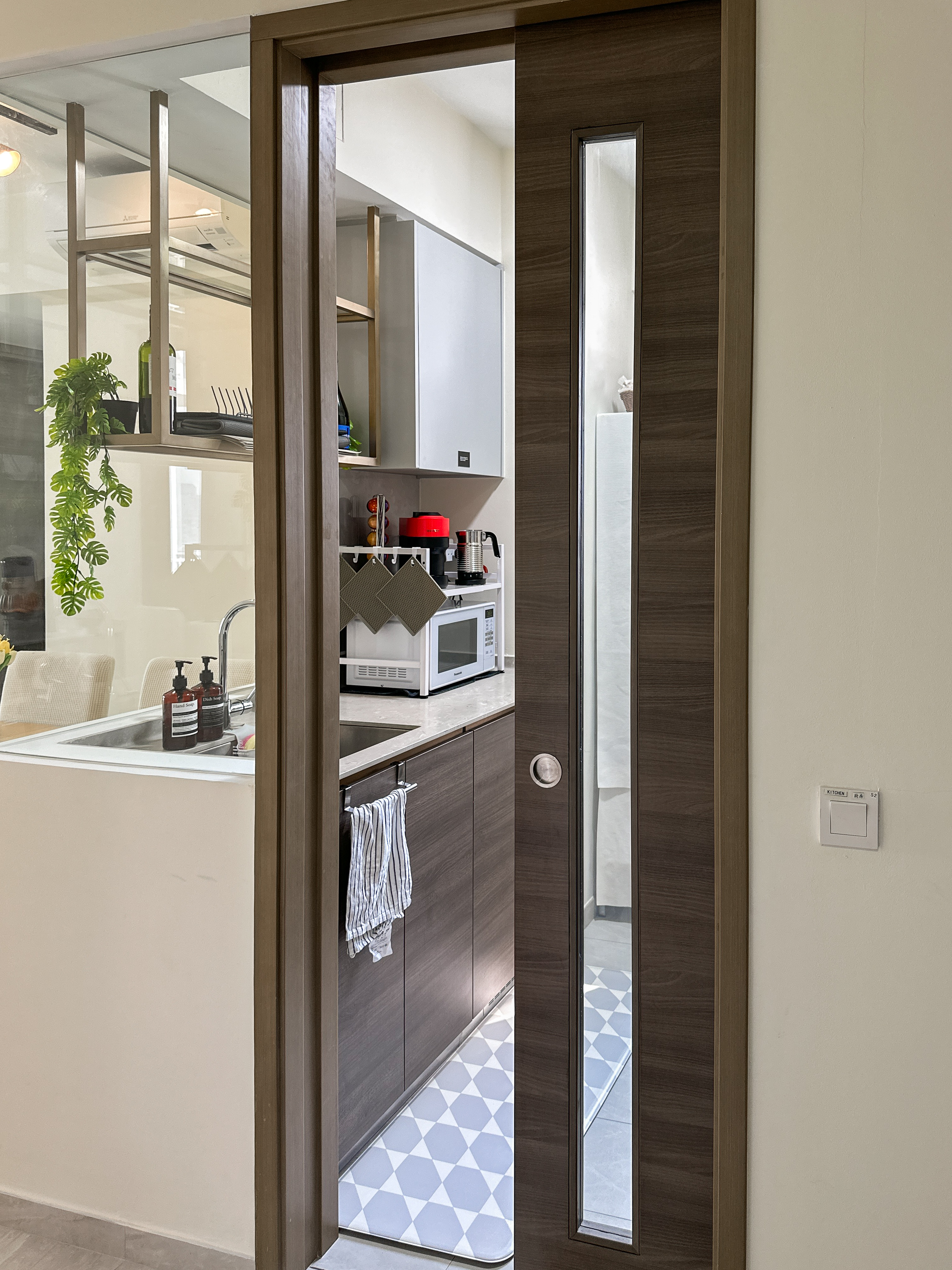 Embrace the simplicity of the kitchen! ✨ - Modern kitchen interior, minimalist design, open doorway, wooden cabinets, sleek