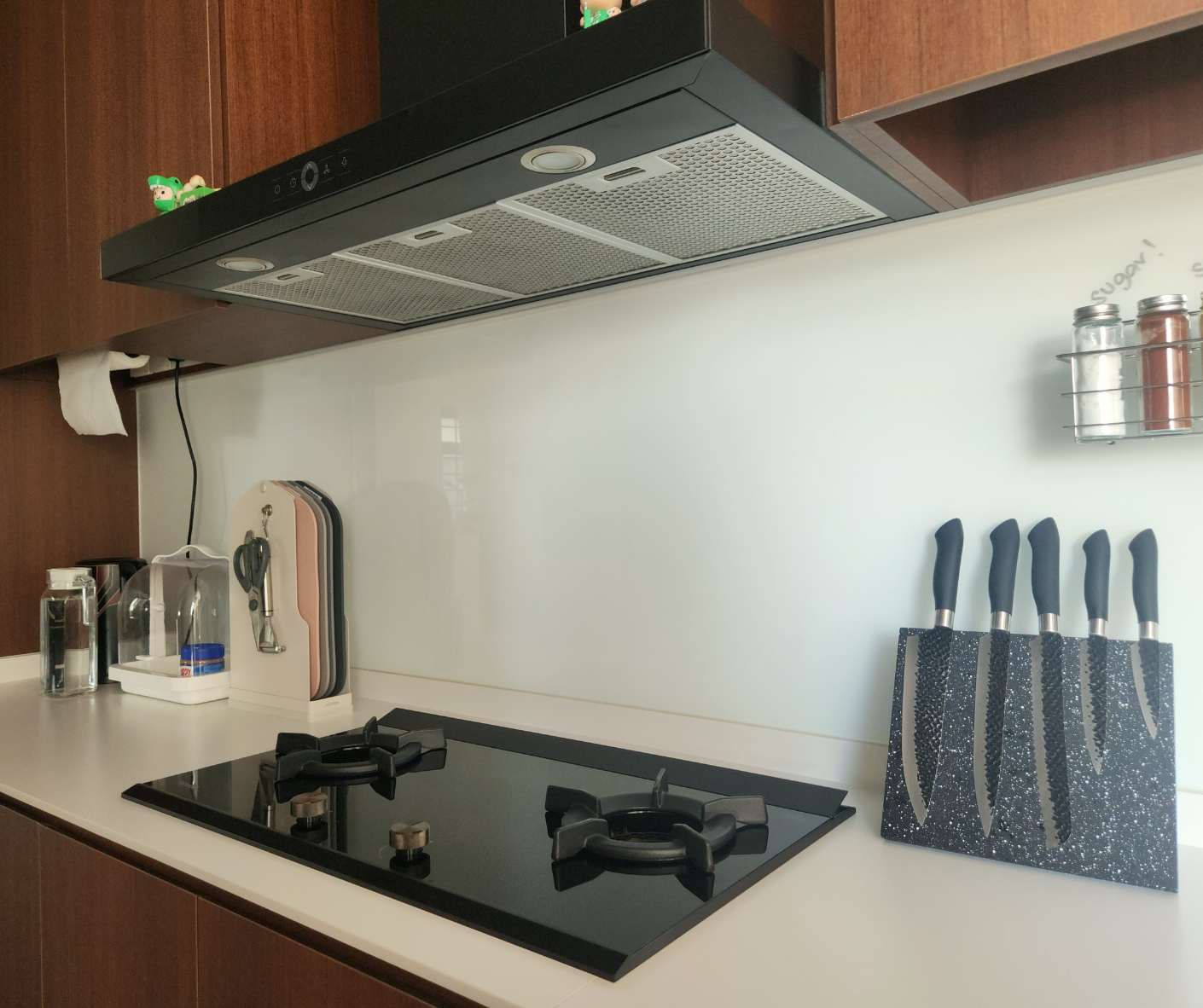 Reimagining Our Kitchen: A Year of Transformation and Our Best Tips - black stovetop, modern kitchen, stainless steel range