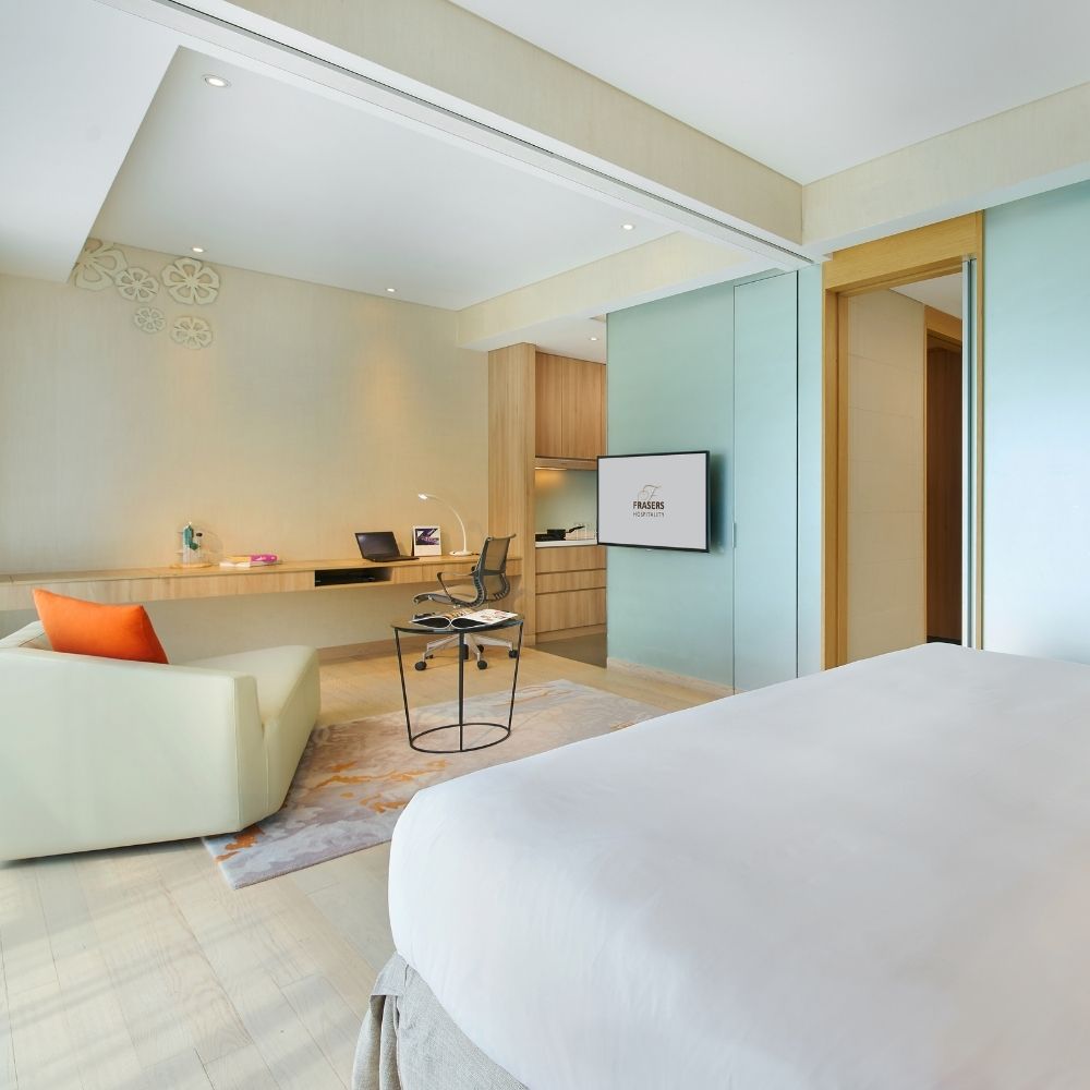 Inspiration from a Staycation: A Lounge Area in Our Bedroom - Modern bedroom with sleek design, minimalist decor, large bed