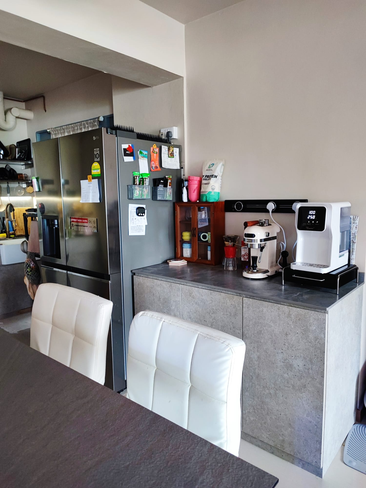 A Low-Cost & Open Concept Kitchen with Stone and Industrial Touches - Stainless steel refrigerator, kitchen counter, coffee