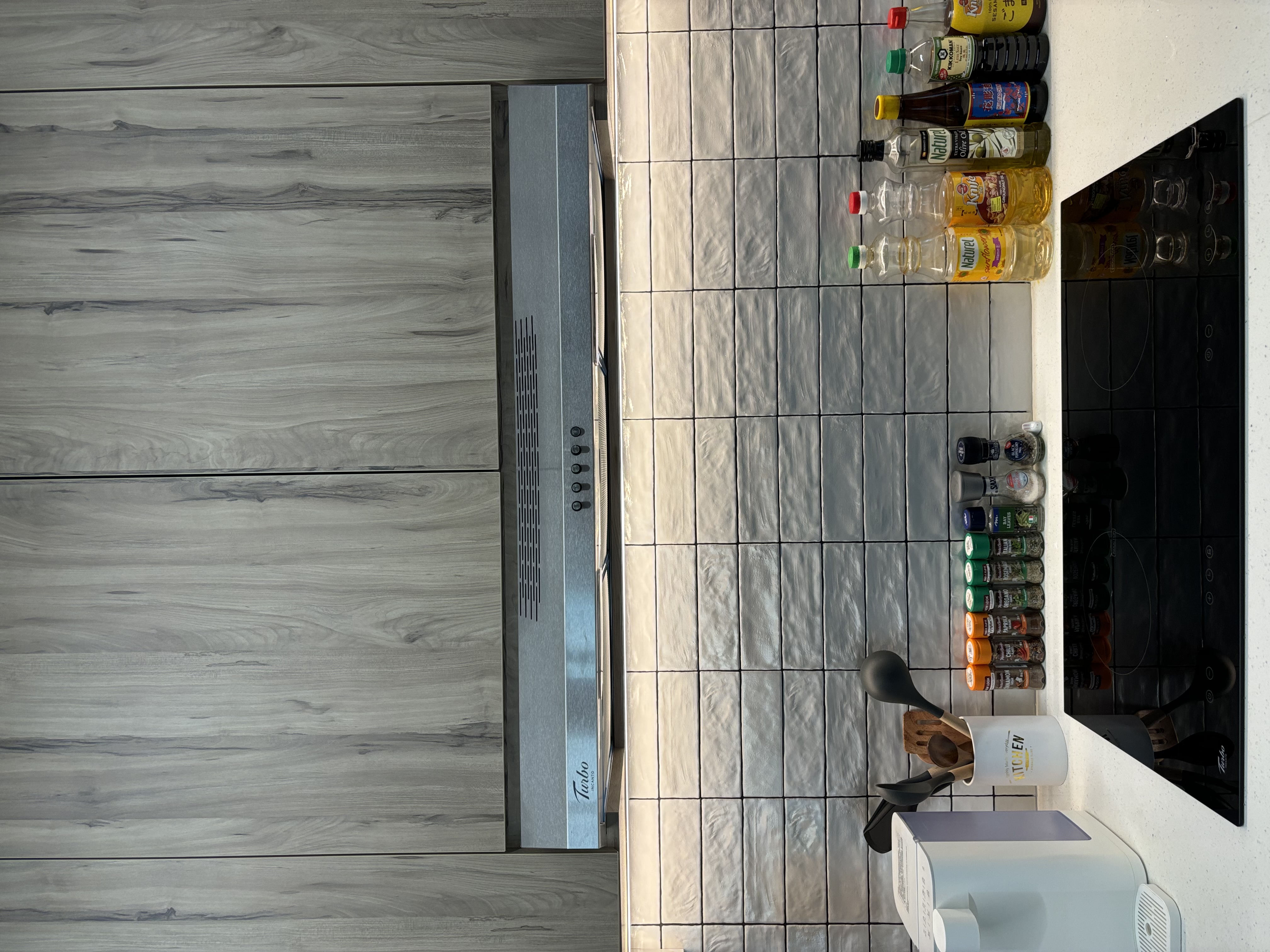 Our Food Playground with Subway Tiles and Pop of Colour - Wooden floor, tiled countertop, modern kitchen, stainless steel