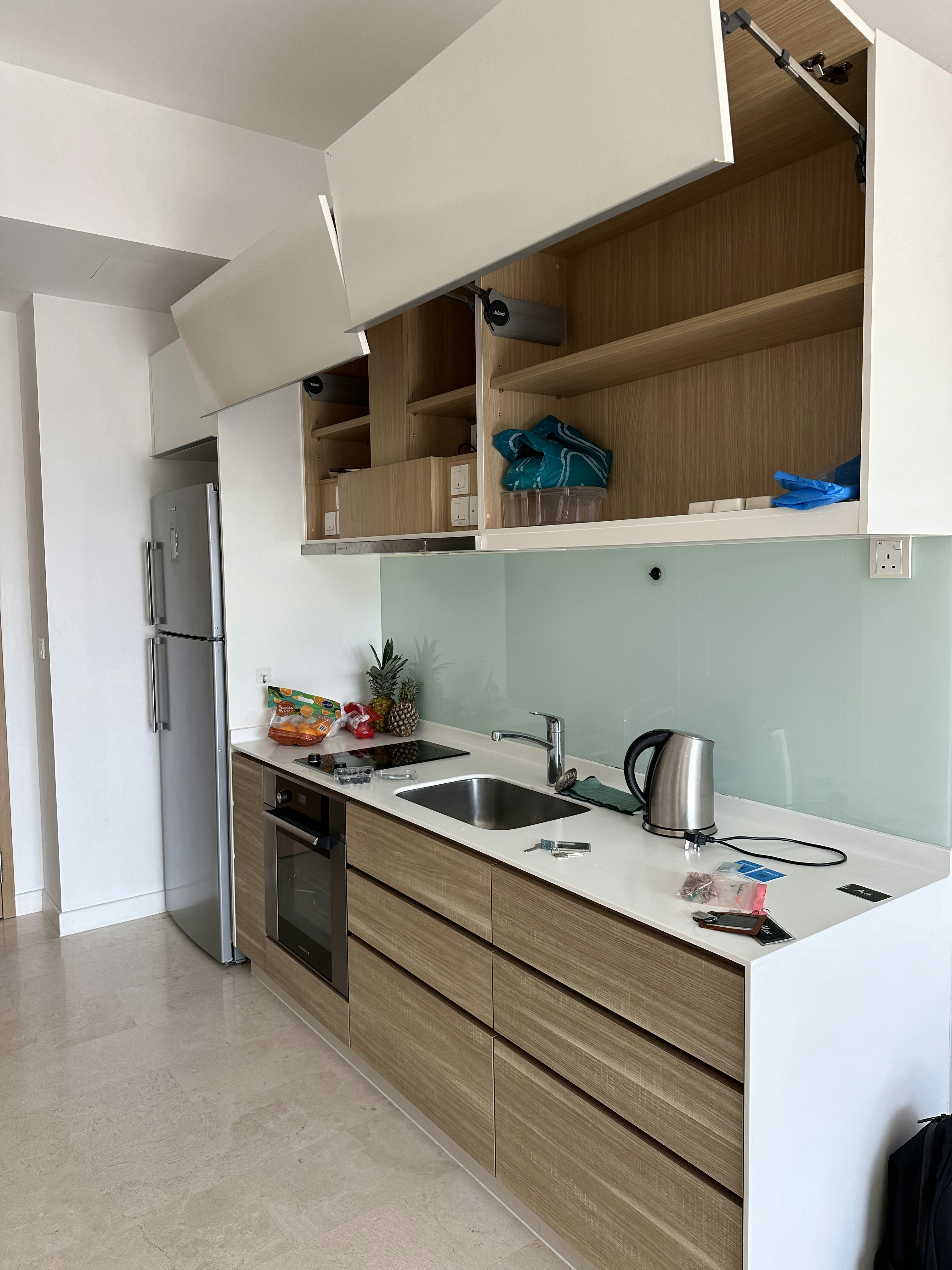 A Tour of Our Modern Kitchen with Fully Integrated Appliances - Modern kitchen with stainless steel refrigerator, wooden