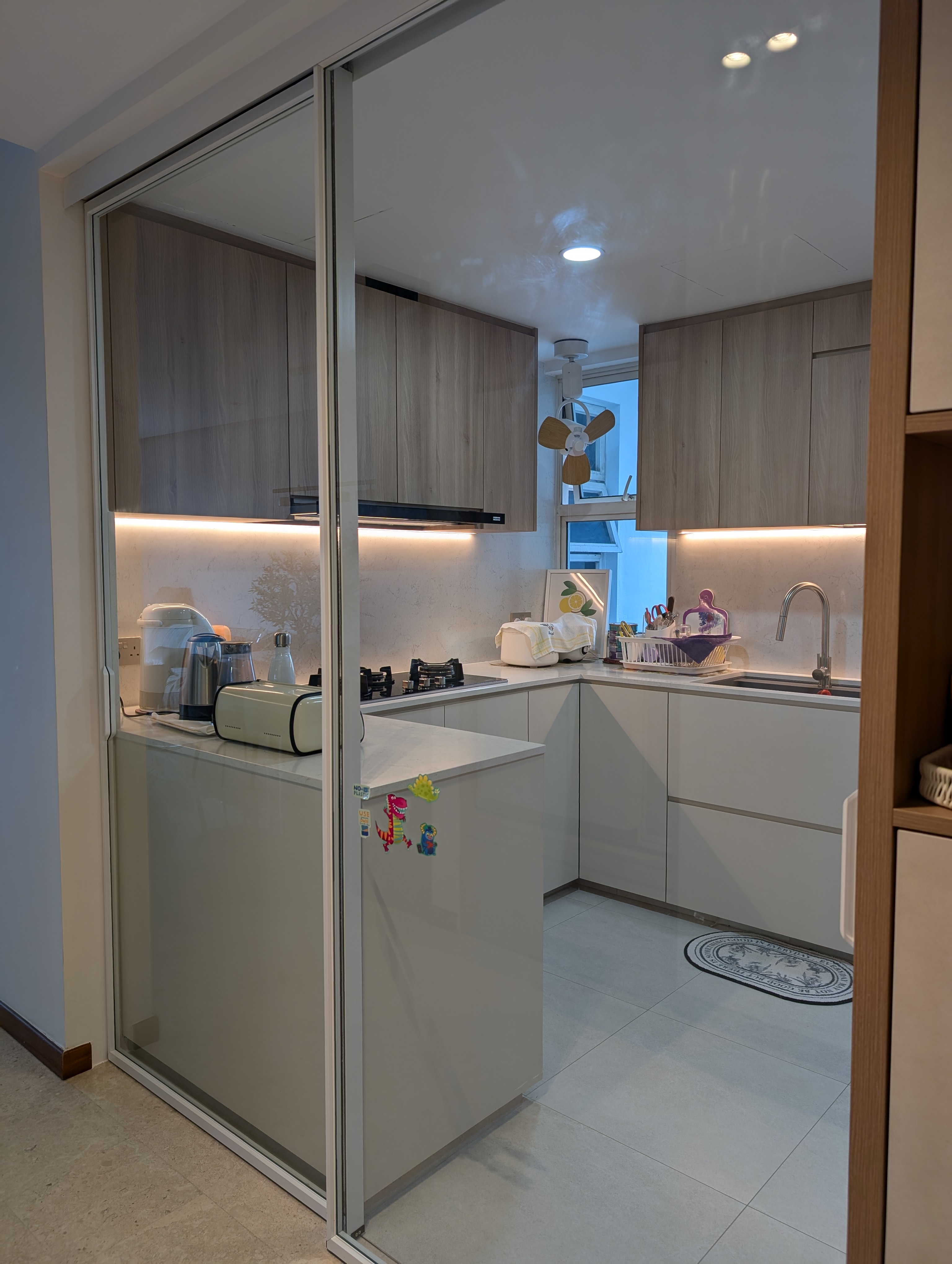 Huh, white cabinets in your kitchen?? - Modern kitchen with glass doors, wooden cabinets, white countertops, under-cabinet