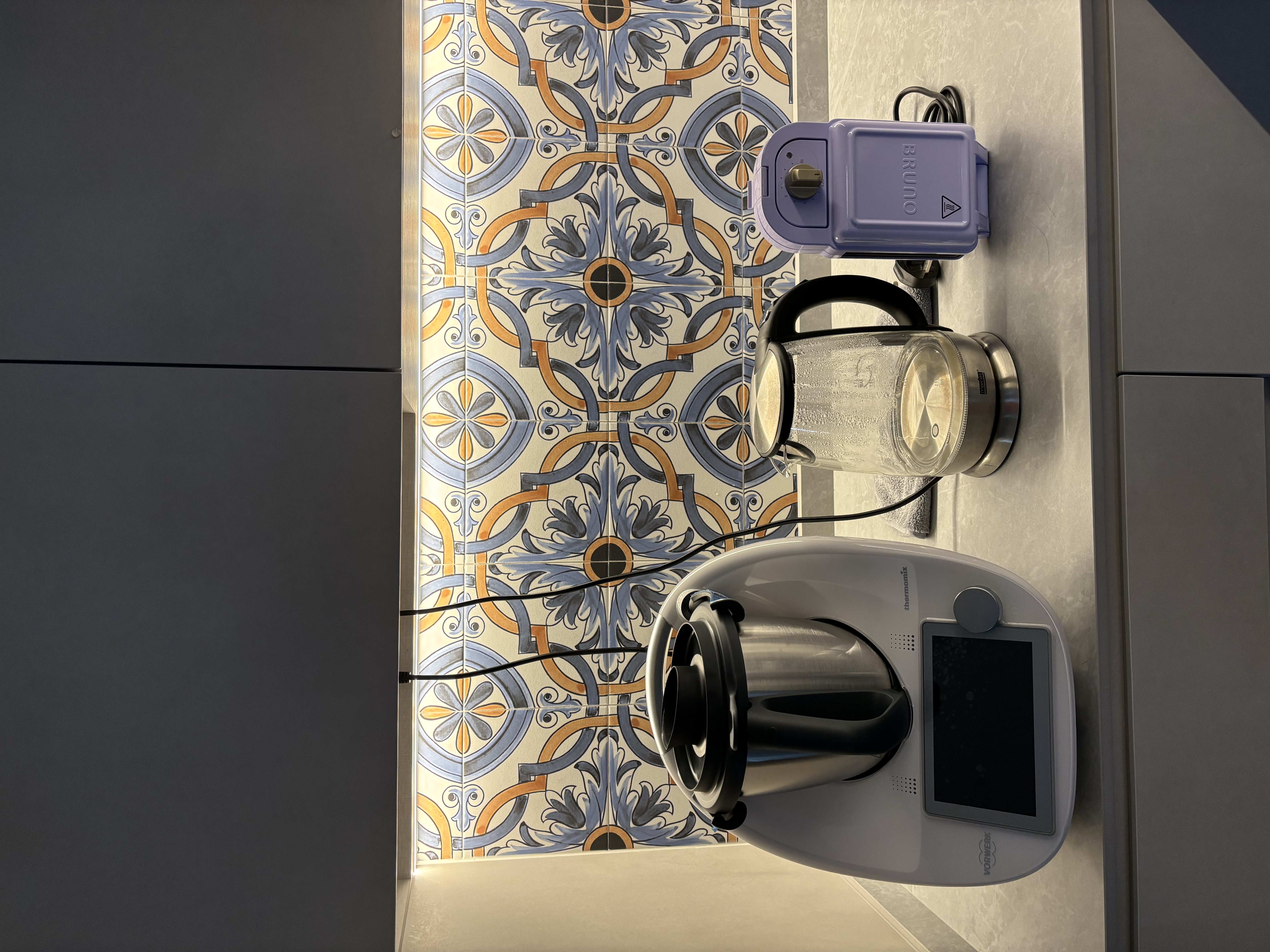 Small tiles for backsplash?! Inside a modern Spanish style kitchen - Elegant kitchen countertop with intricate tile design