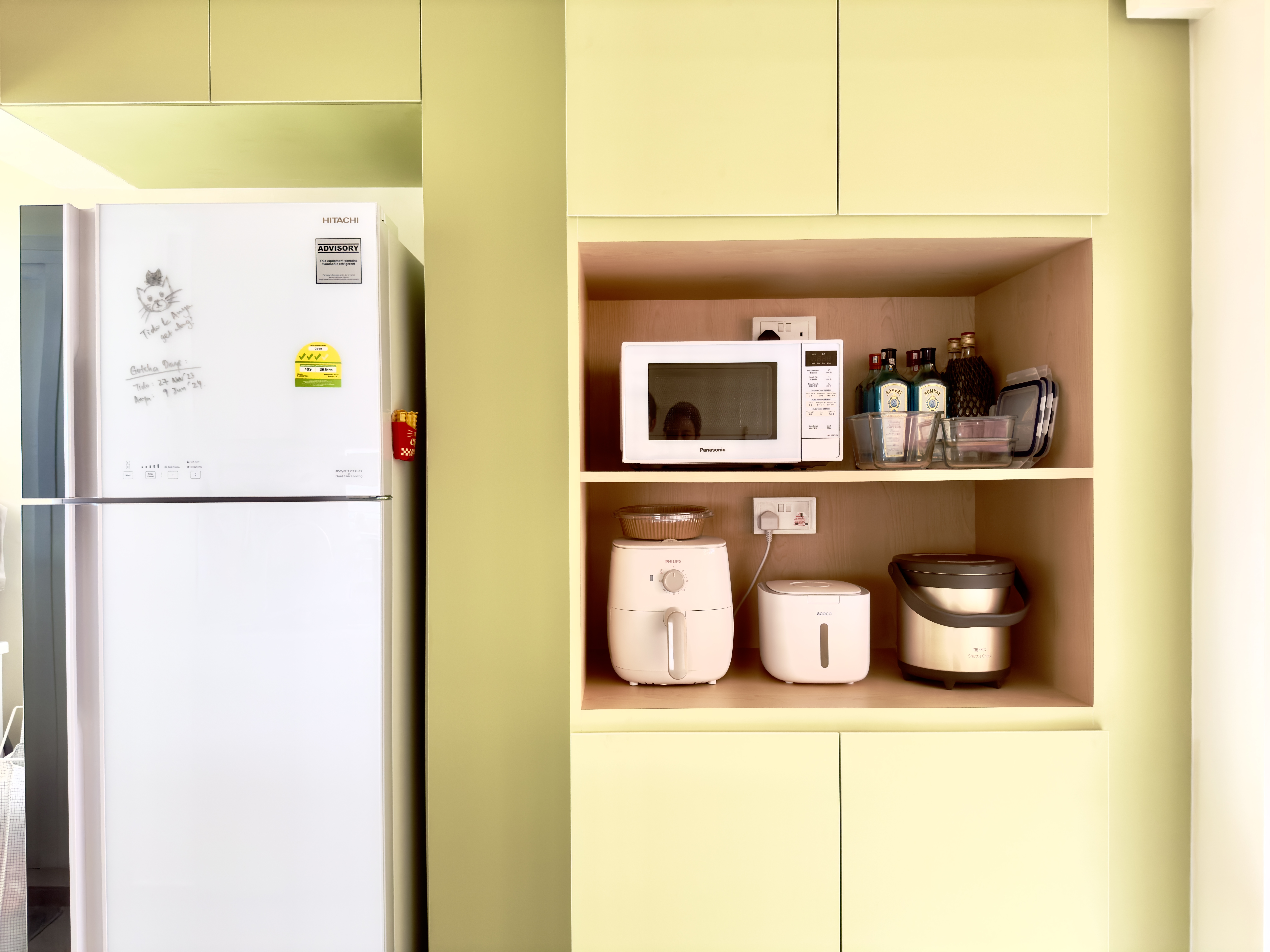 Our bright green open-concept kitchen - Kitchen cabinets, microwave, refrigerator, white refrigerator, yellow cabinets