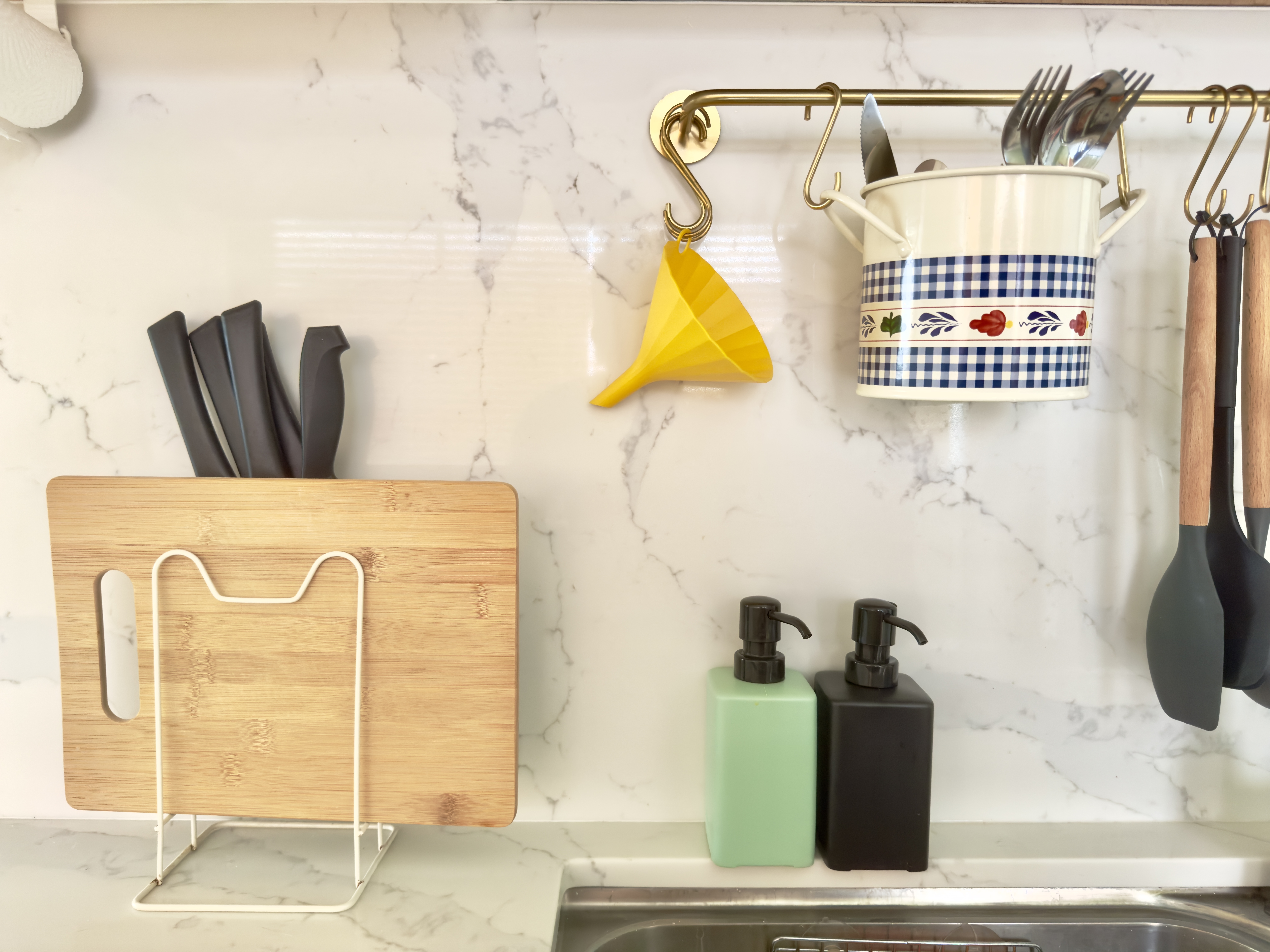 Our bright green open-concept kitchen - White marble countertop, kitchen sink, wooden cutting board, metal wire rack, yellow