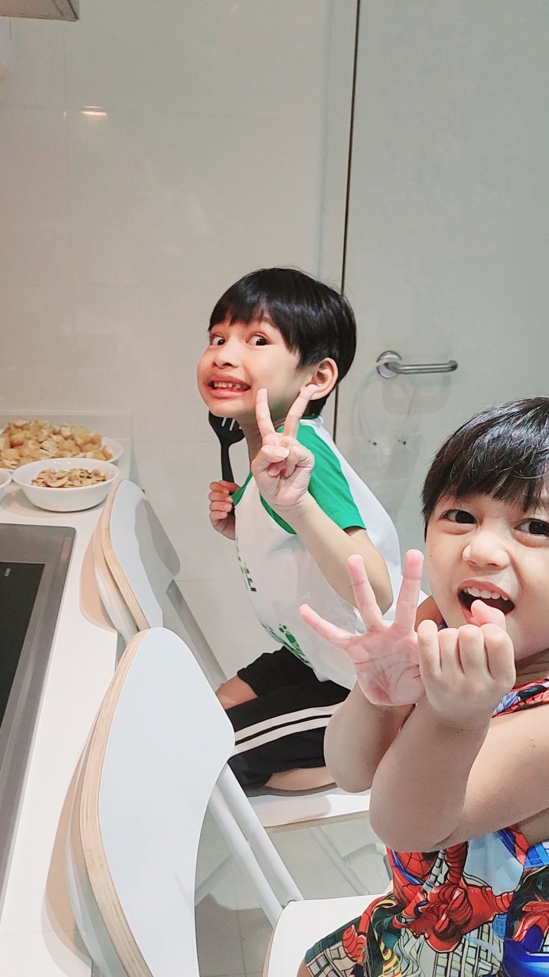 Weekend routine by PunggoHField - Two children sitting at a modern kitchen counter, One child making a peace sign with both