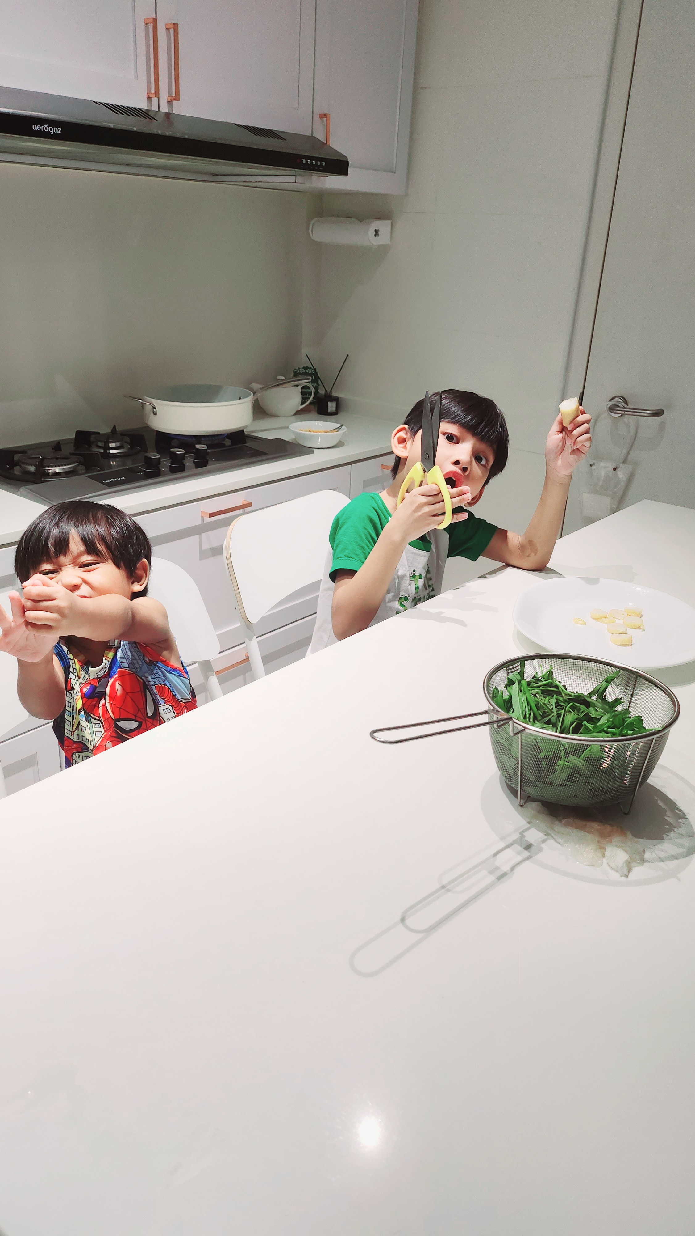 Weekend routine by PunggoHField - Children sitting at kitchen table, holding food, green leafy vegetables in a strainer