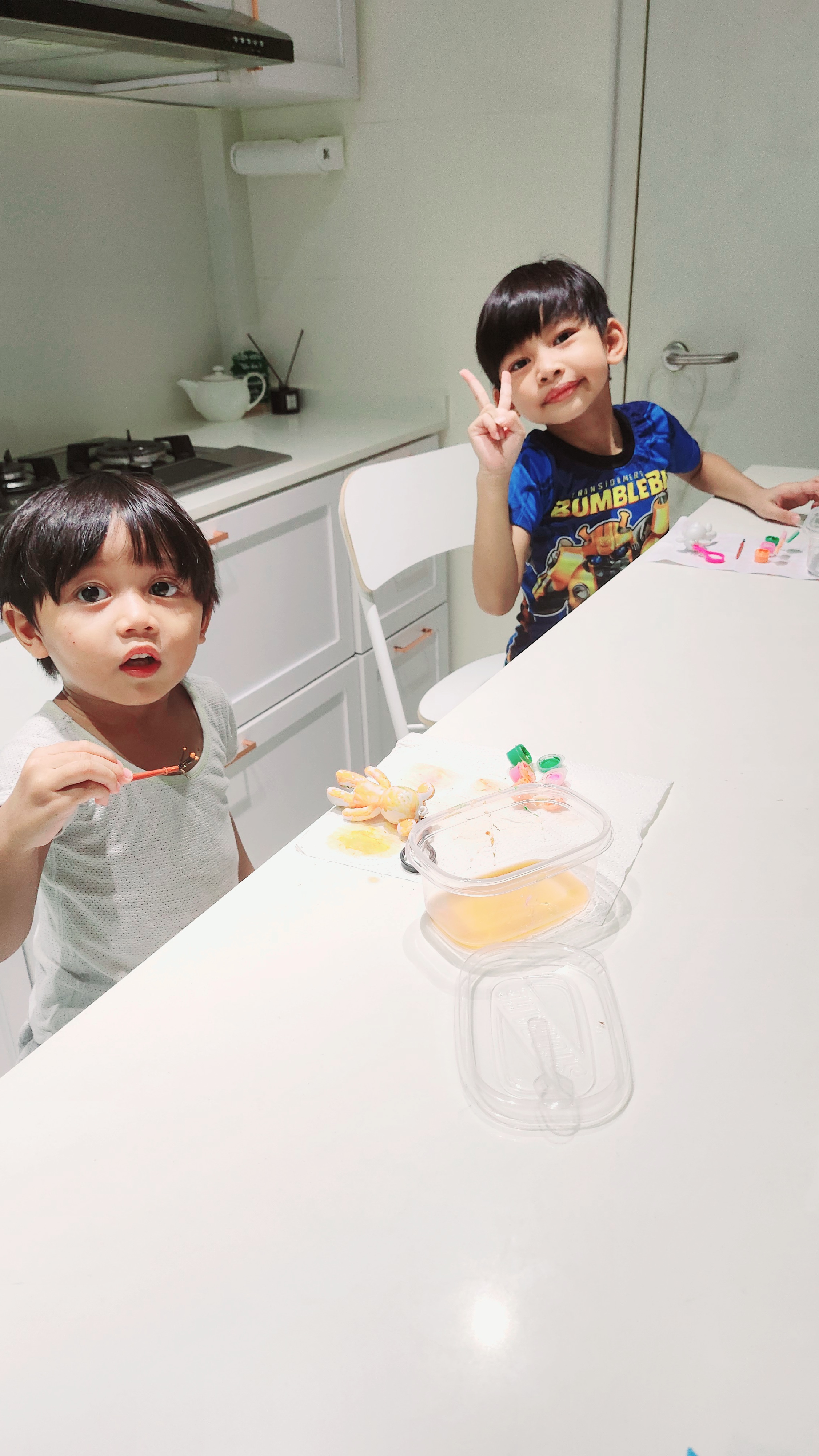 Weekend routine by PunggoHField - Child making peace sign, child holding toothbrush, child sitting at kitchen counter, child
