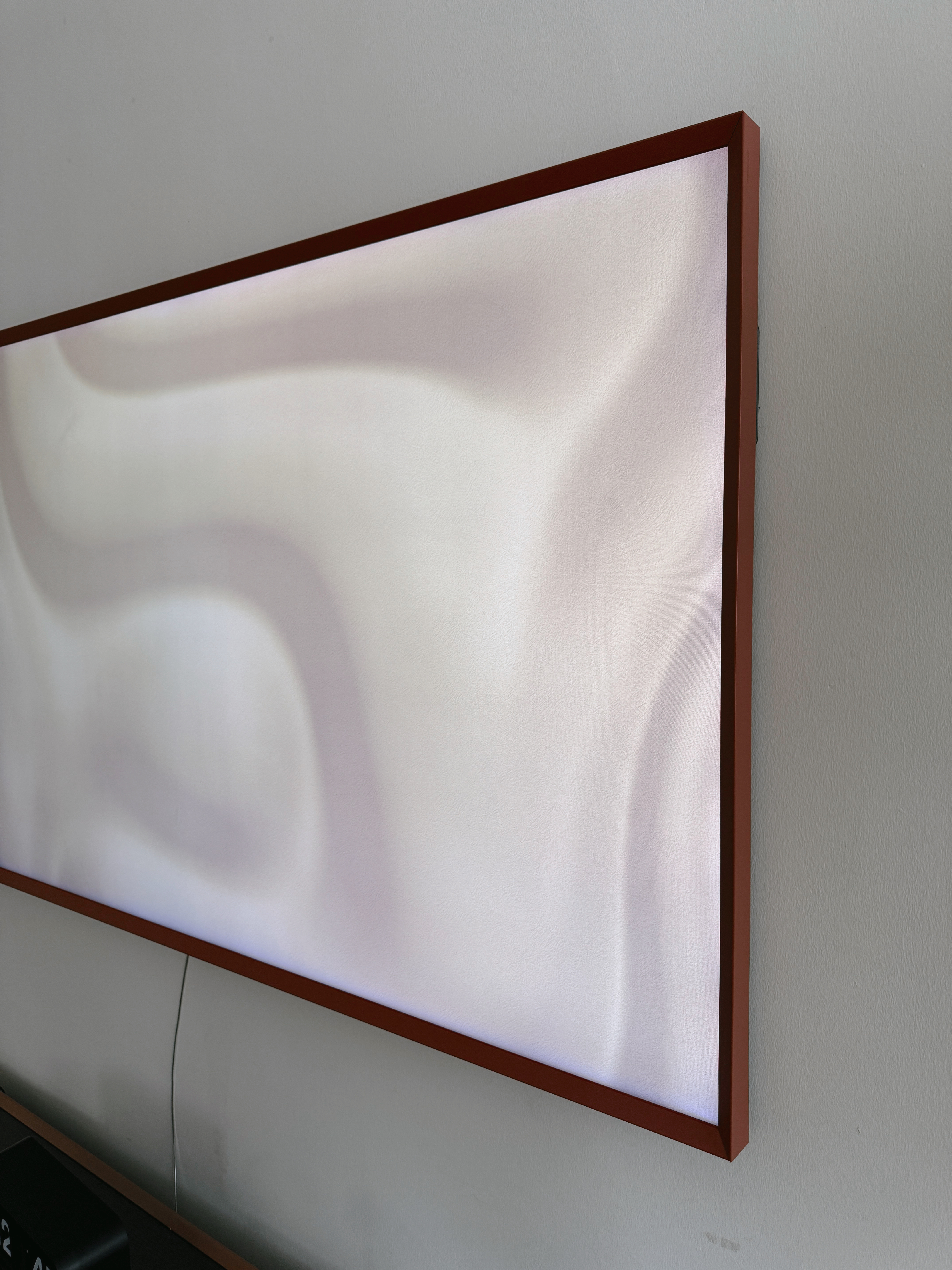 Turn Your House into a Home with These Personal Favorites - Rectangular wall-mounted television with sleek, dark brown frame