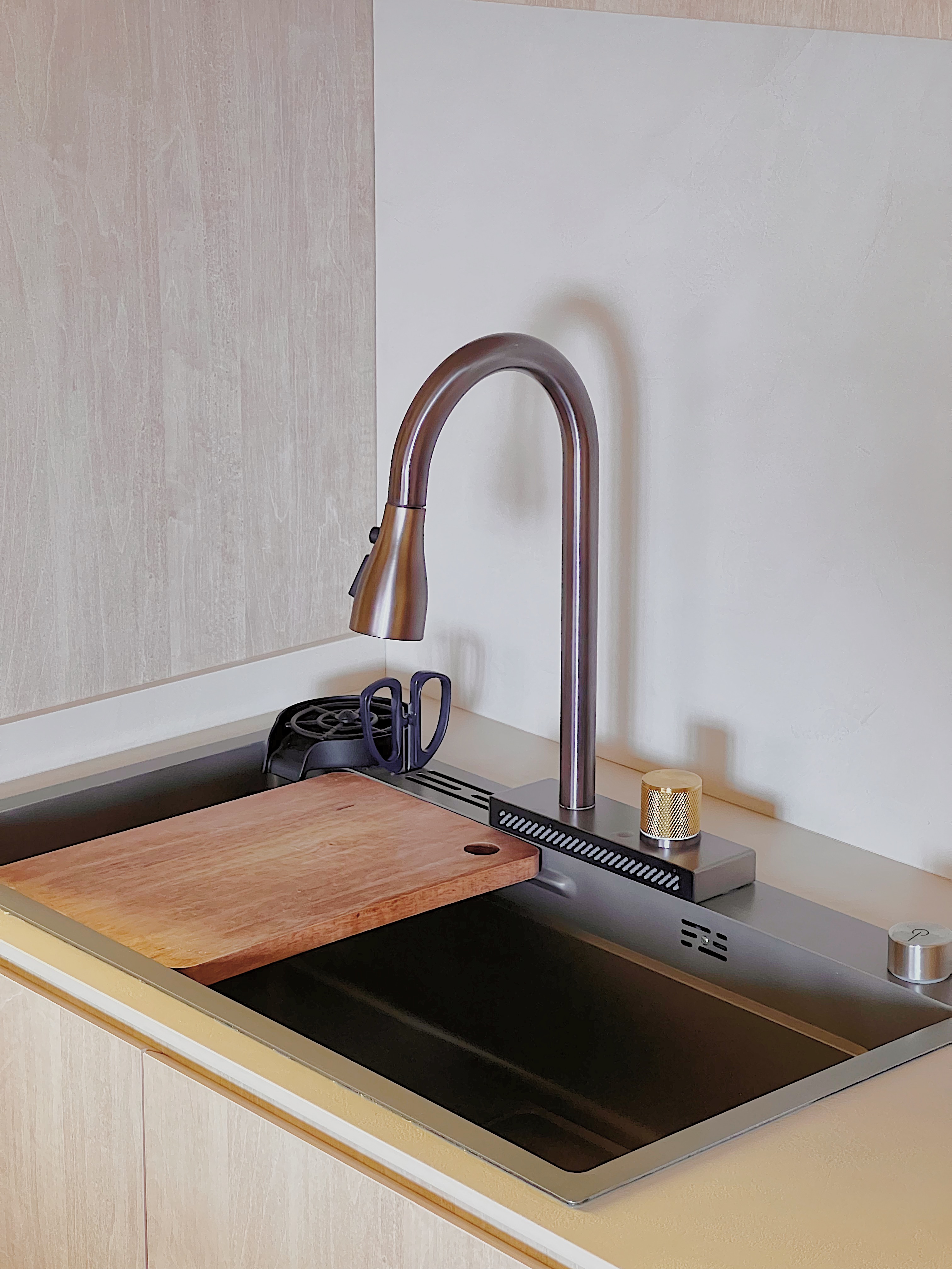 Whipping Up Meals on our Peninsula Stove - Modern kitchen countertop, stainless steel faucet, wooden cutting board, black