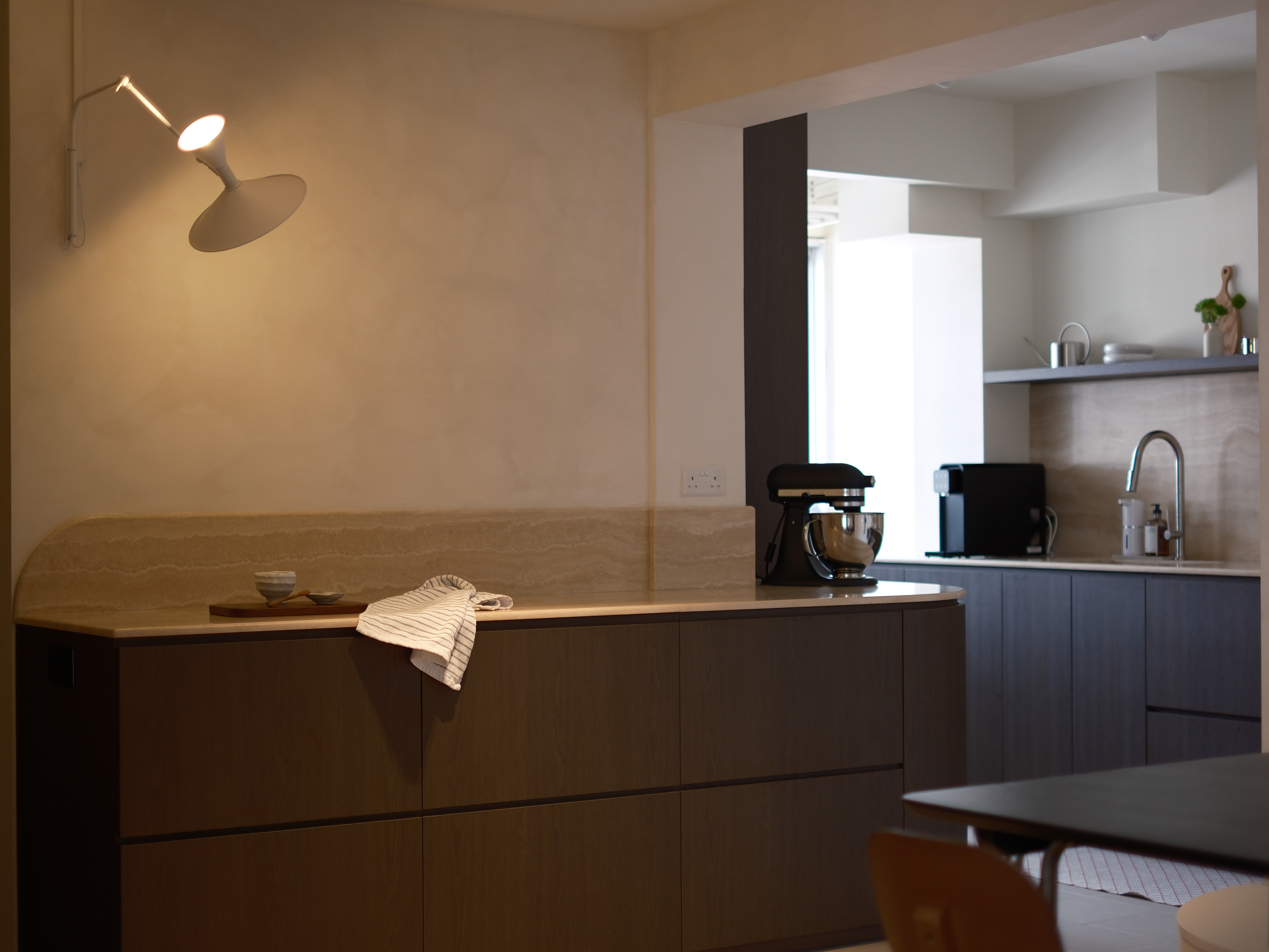 Our Travertine & Dark Oak Kitchen: Open-Concept with Ample Countertop - modern kitchen, minimalist design, cozy atmosphere