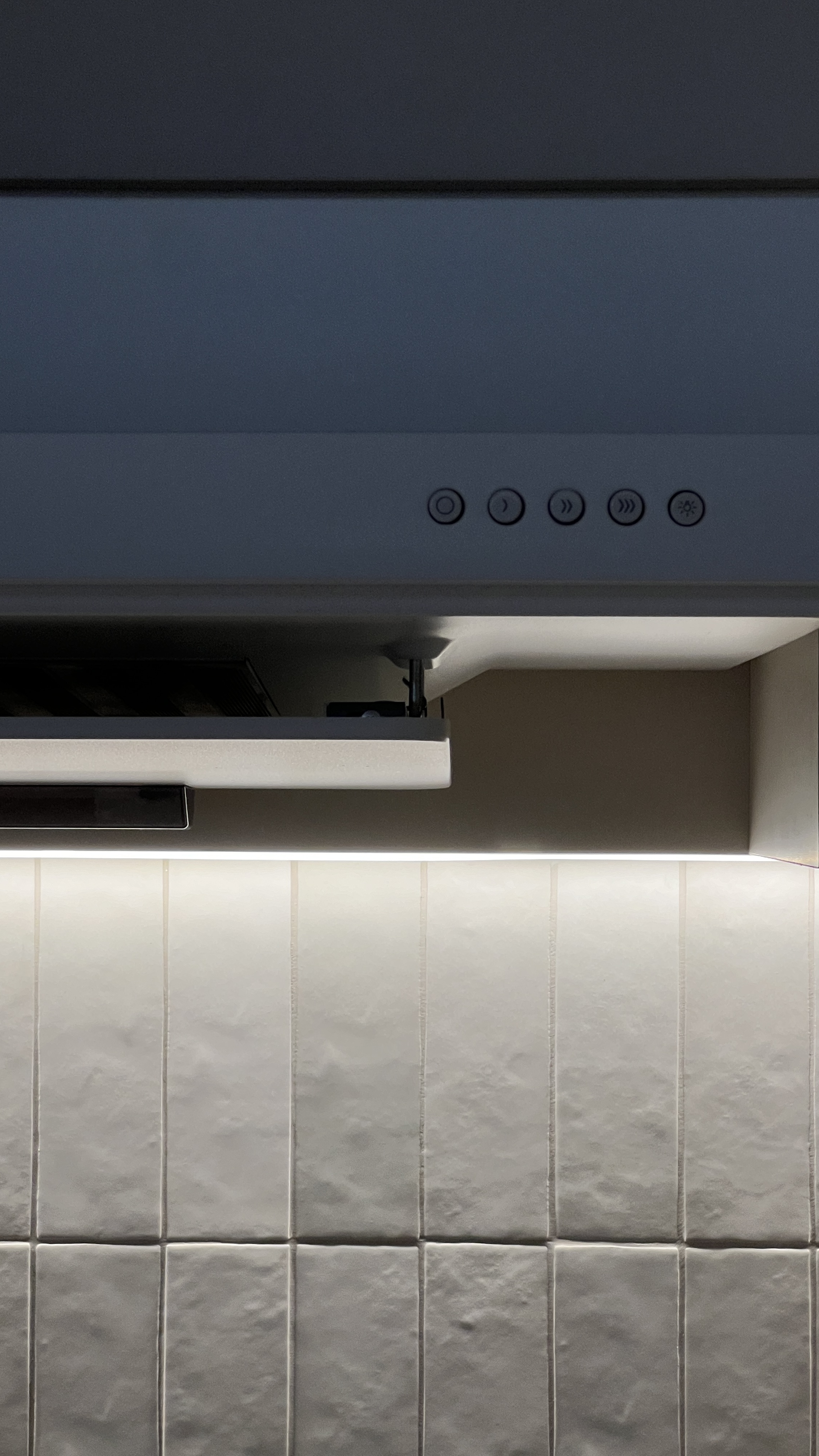 Our Kitchen: Soft Palettes and Clean Designs - Kitchen hood with control panel, under-cabinet lighting, white tiled