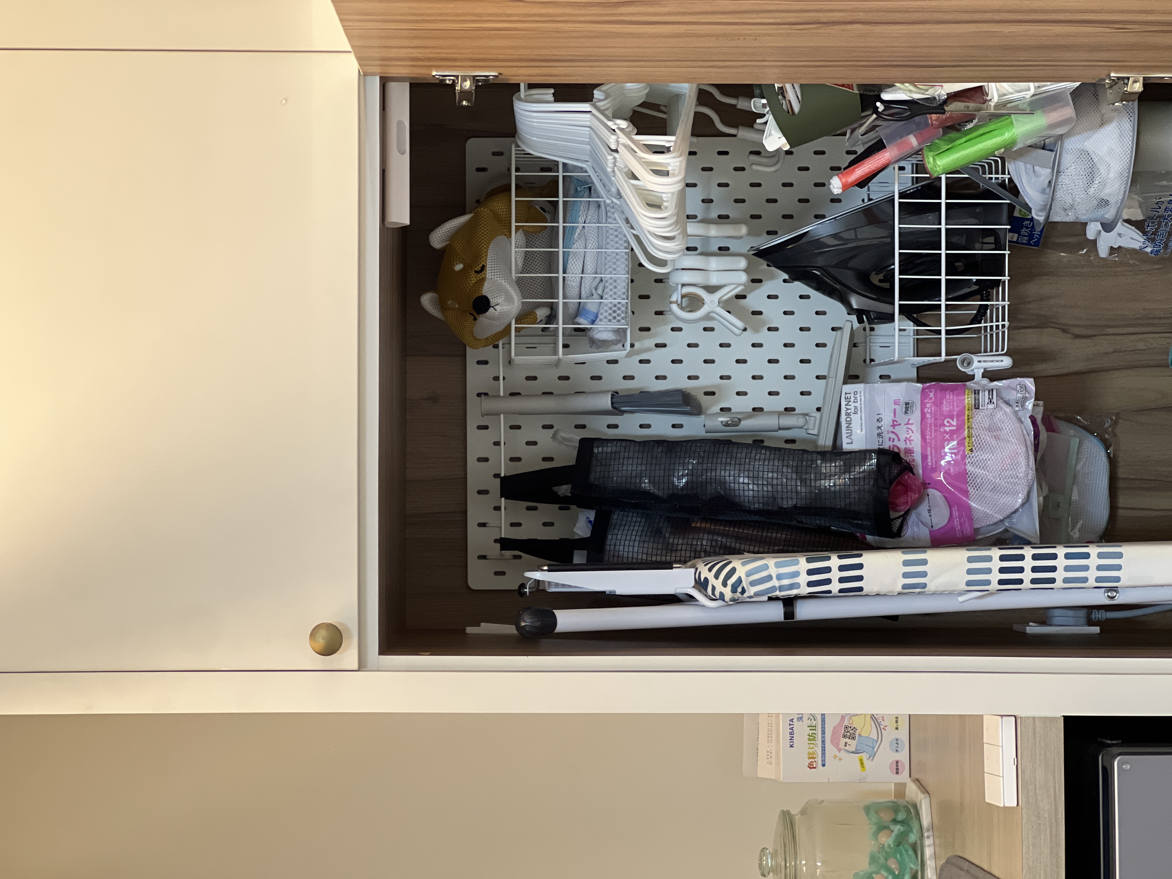 Our Kitchen: Soft Palettes and Clean Designs - Laundry basket, white hangers, black mesh bag, pink laundry detergent