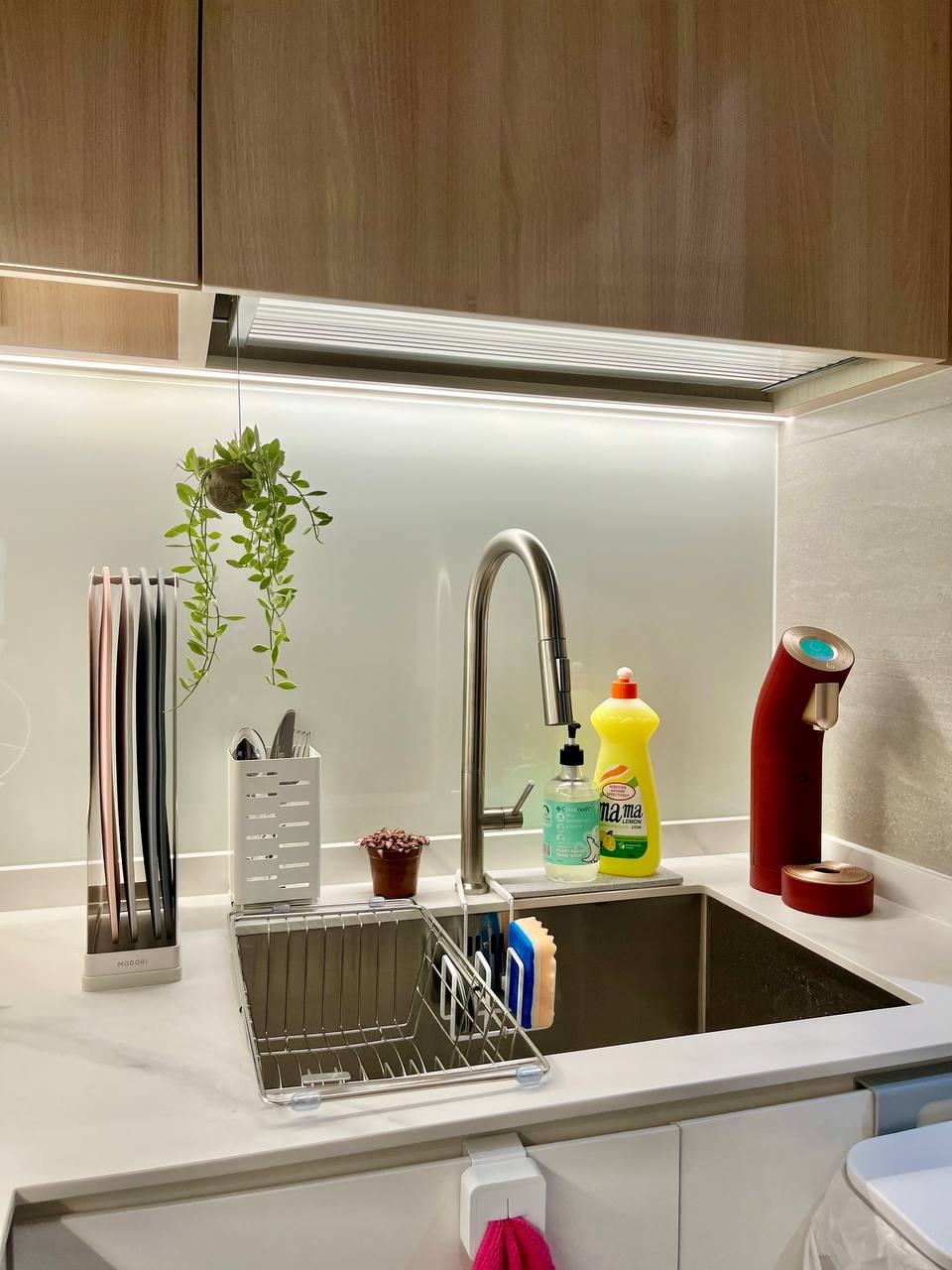 Turning a Small L-Shaped Kitchen Look and Feel Bigger  - Modern kitchen sink area, sleek design, stainless steel faucet