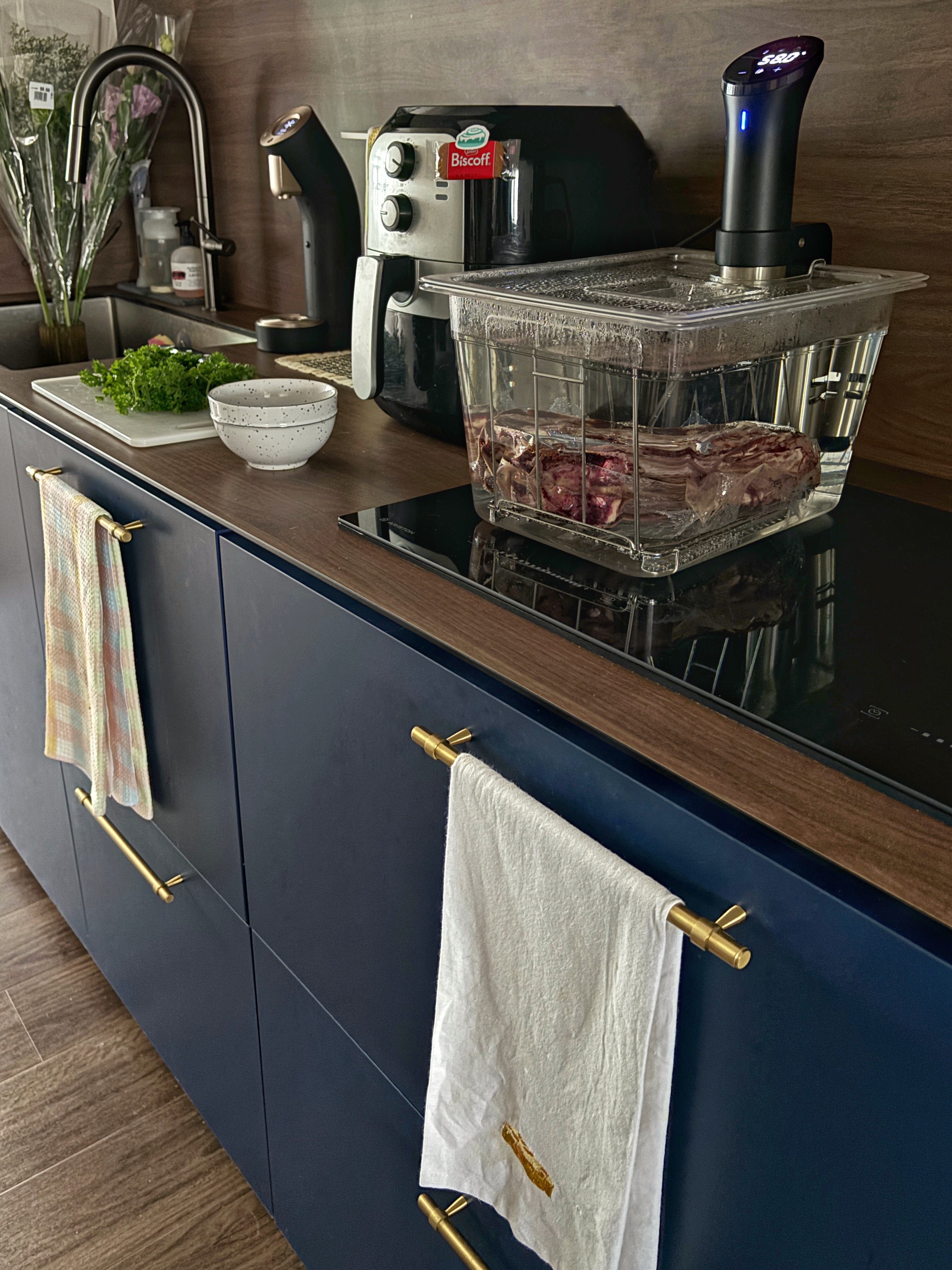 Hosting tips for Weekday Dinner Parties - modern kitchen countertop, stainless steel appliances, clear glass dish, fresh