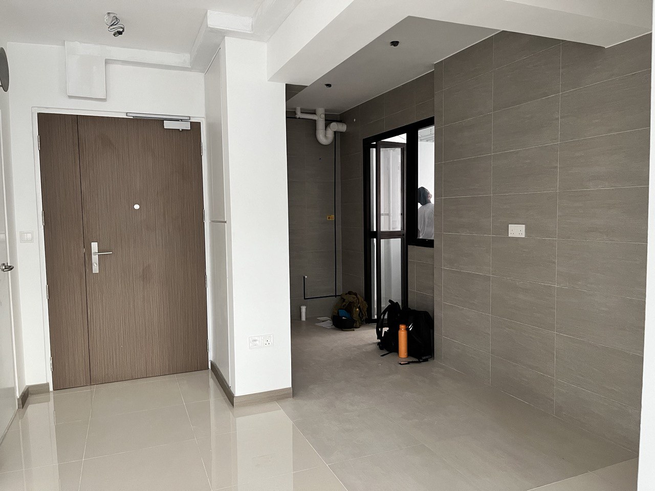 Turning a Small L-Shaped Kitchen Look and Feel Bigger  - Modern minimalist hallway, tiled floor, wooden door, white walls