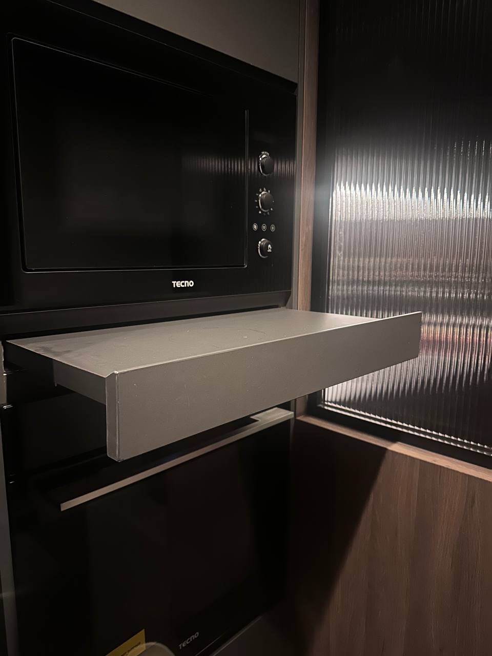 Warm and Cozy Kitchen: A Daily Ritual of Comfort - Black Tecom microwave, sleek design, modern kitchen, integrated oven