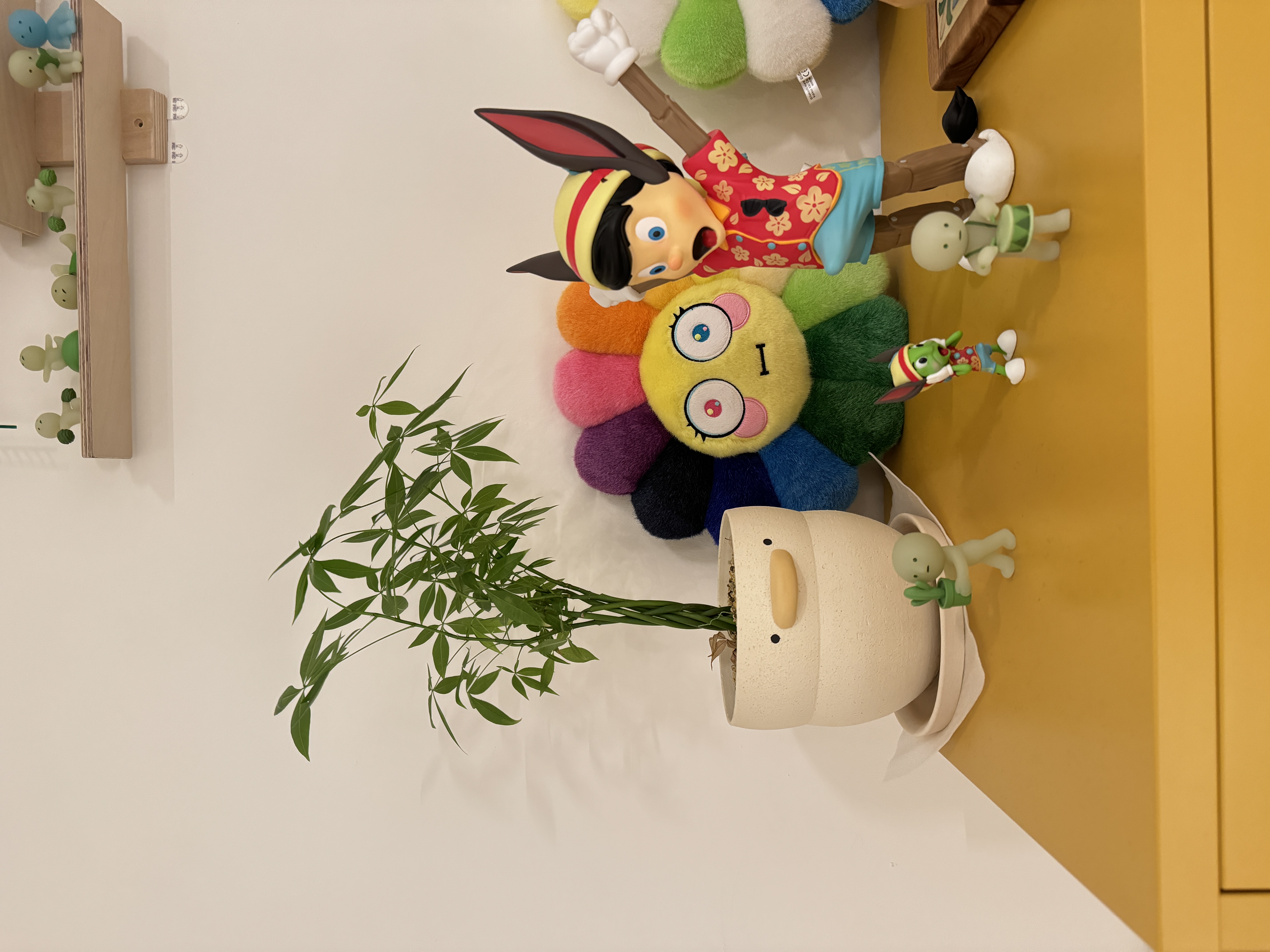 Our First Taste of Parenthood with Our Plant Babies 🌱 - Colorful plush toys, green bamboo plant, yellow and green character