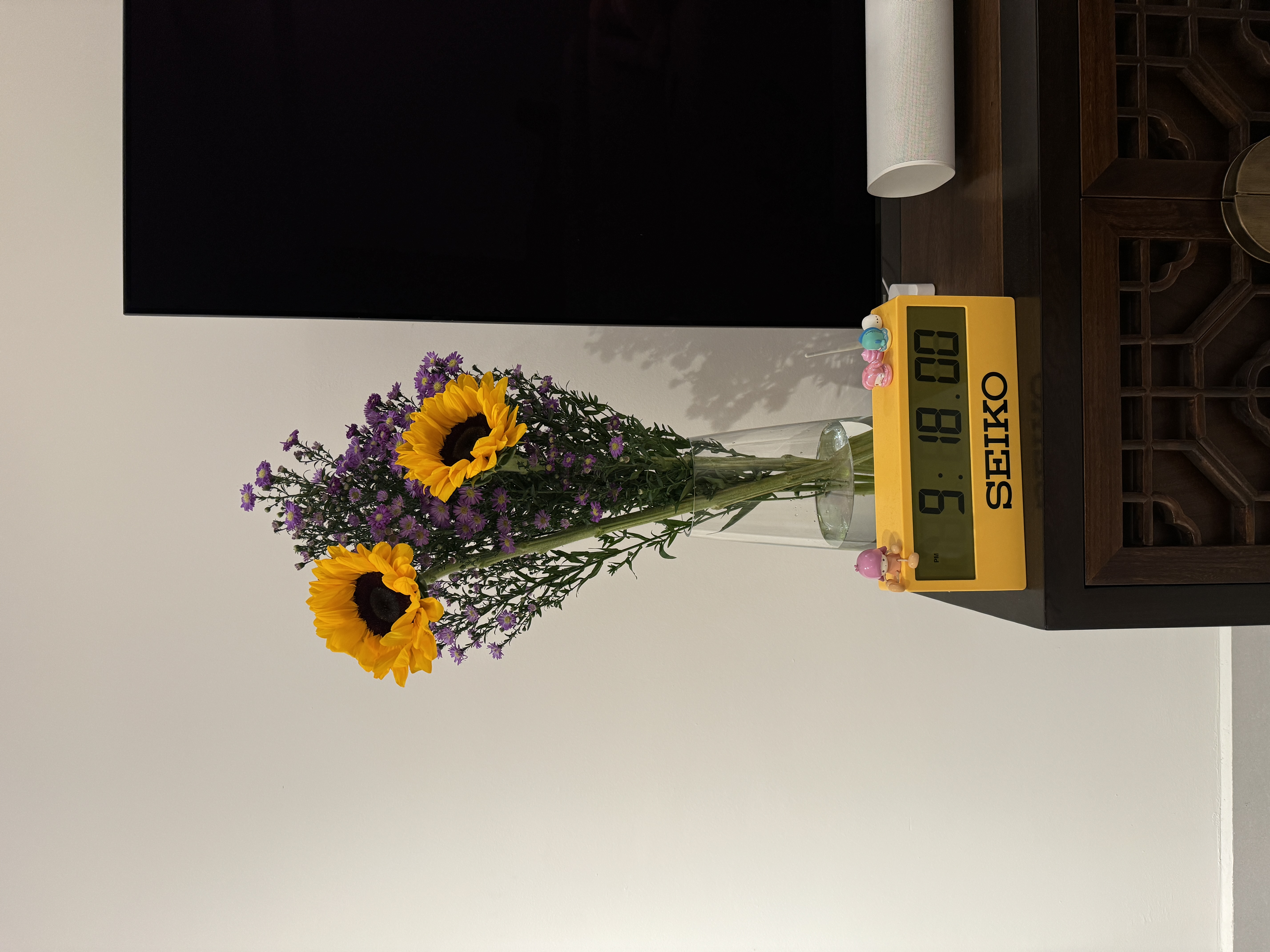 Our First Taste of Parenthood with Our Plant Babies 🌱 - vibrant sunflowers and purple flowers in a vase, digital scale with